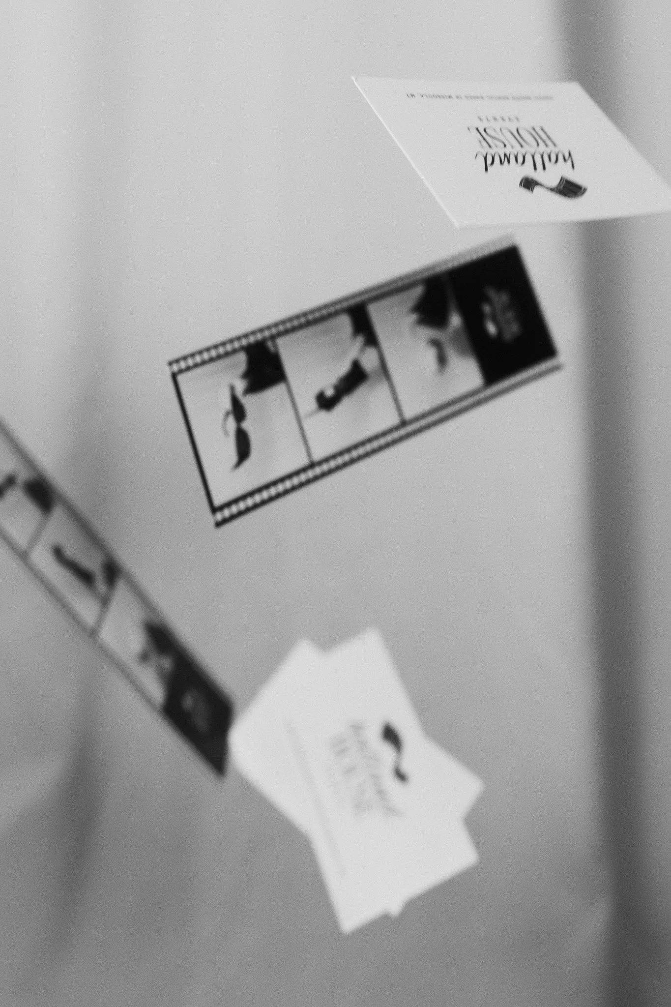 Black and white film strips with four frames and a small card that reads "Halland House"