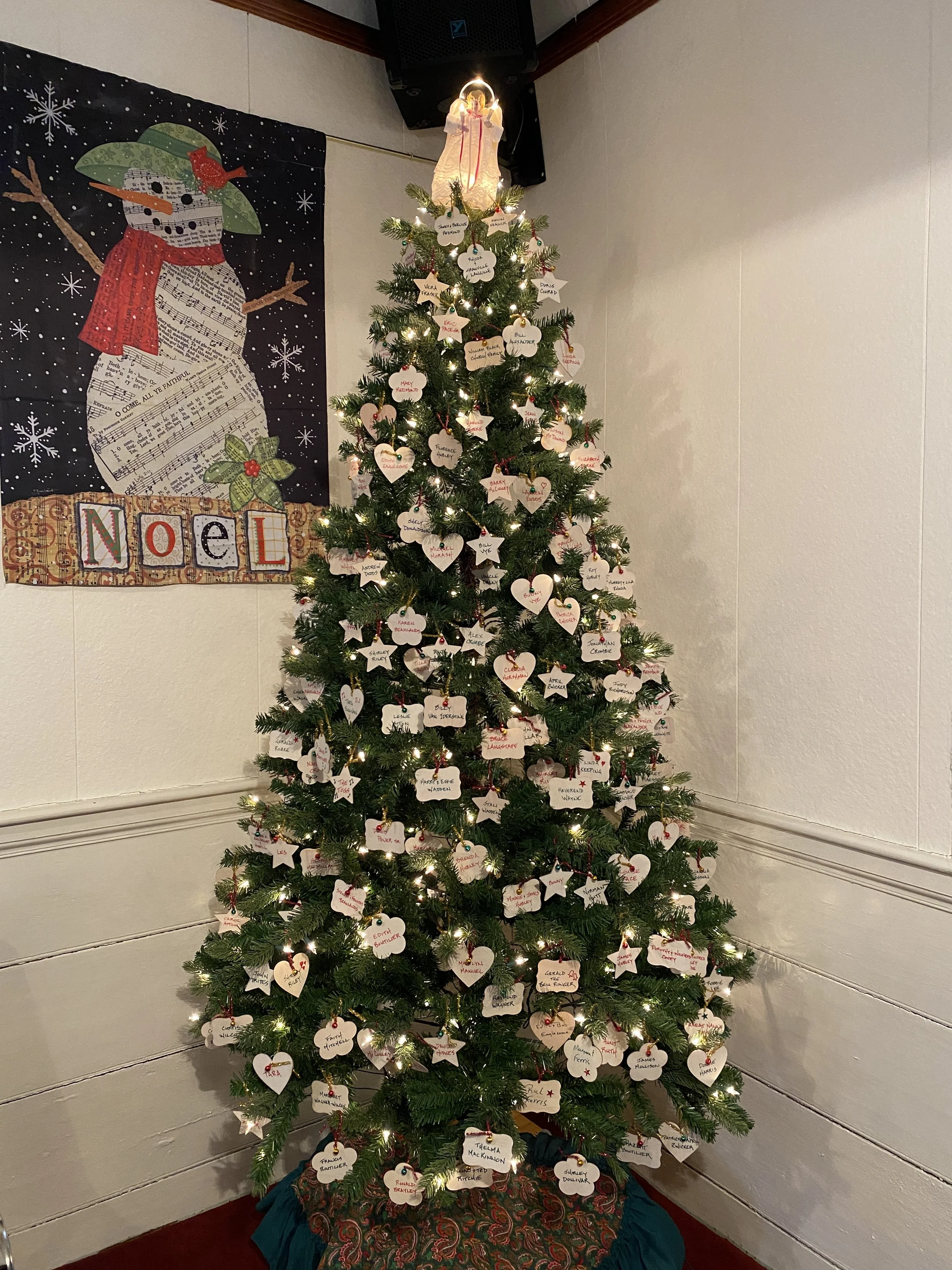 The Christmas tree that graces our sanctuary is adorned with wooden ornaments on which has been written the names of those we remember and celebrate at Christas time.