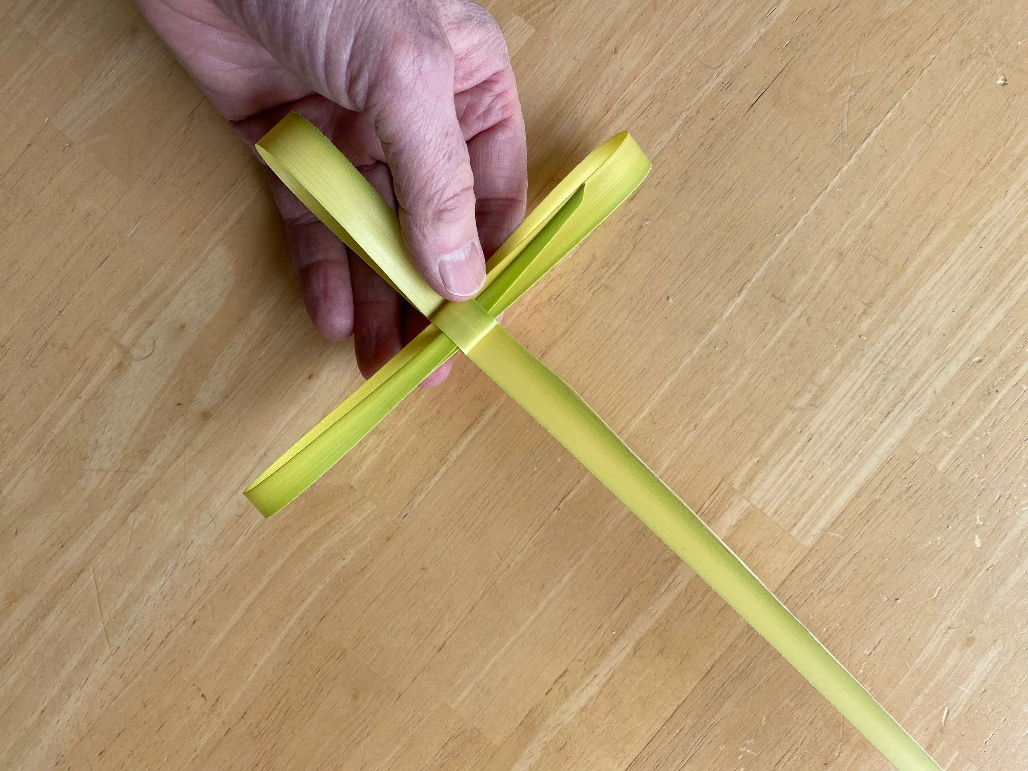 A person has weaved a small cross from a palm frond to decorate the sanctuary for Palm Sunday.