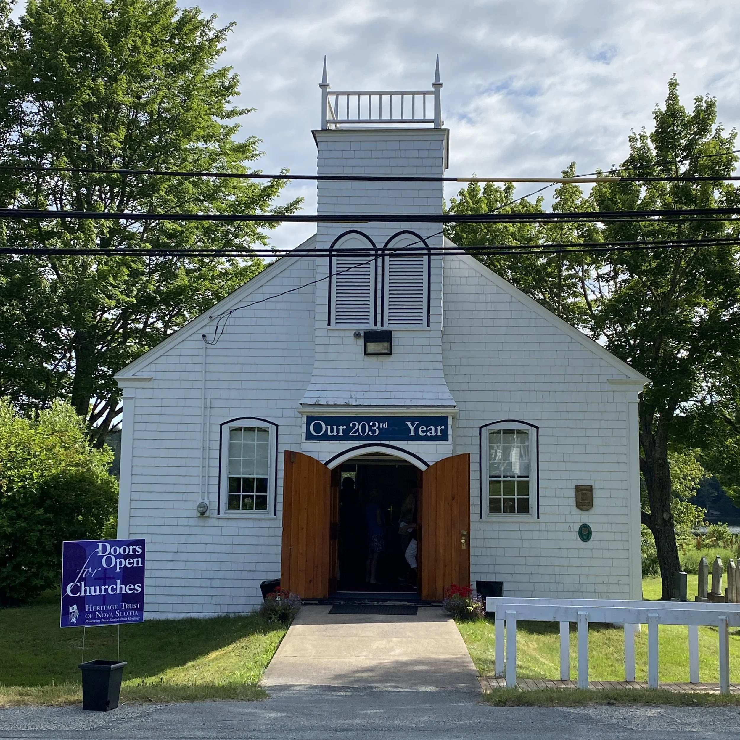 The church with its doors wide open welcoming visitors to Doors Open for Churches an event run by Heritage Nova Scotia. The banner over the church door celebrates our 203rd anniversary.