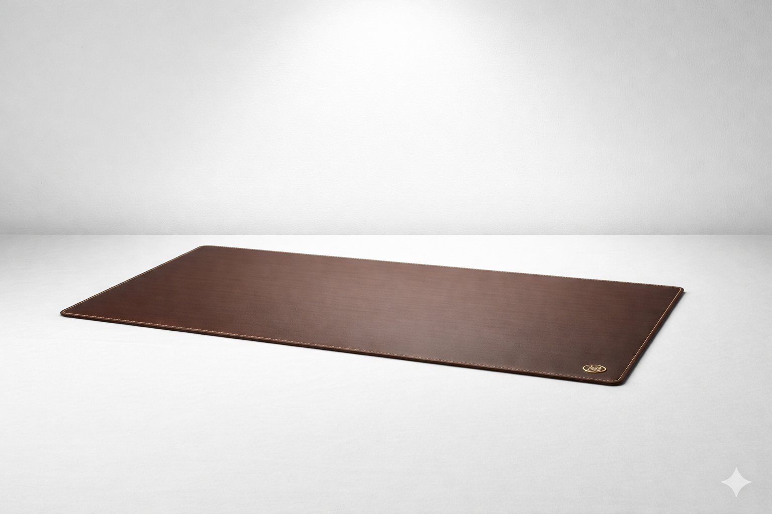 A rectangular brown leather desk mat with white stitching along the edges, placed on a white surface against a white background.