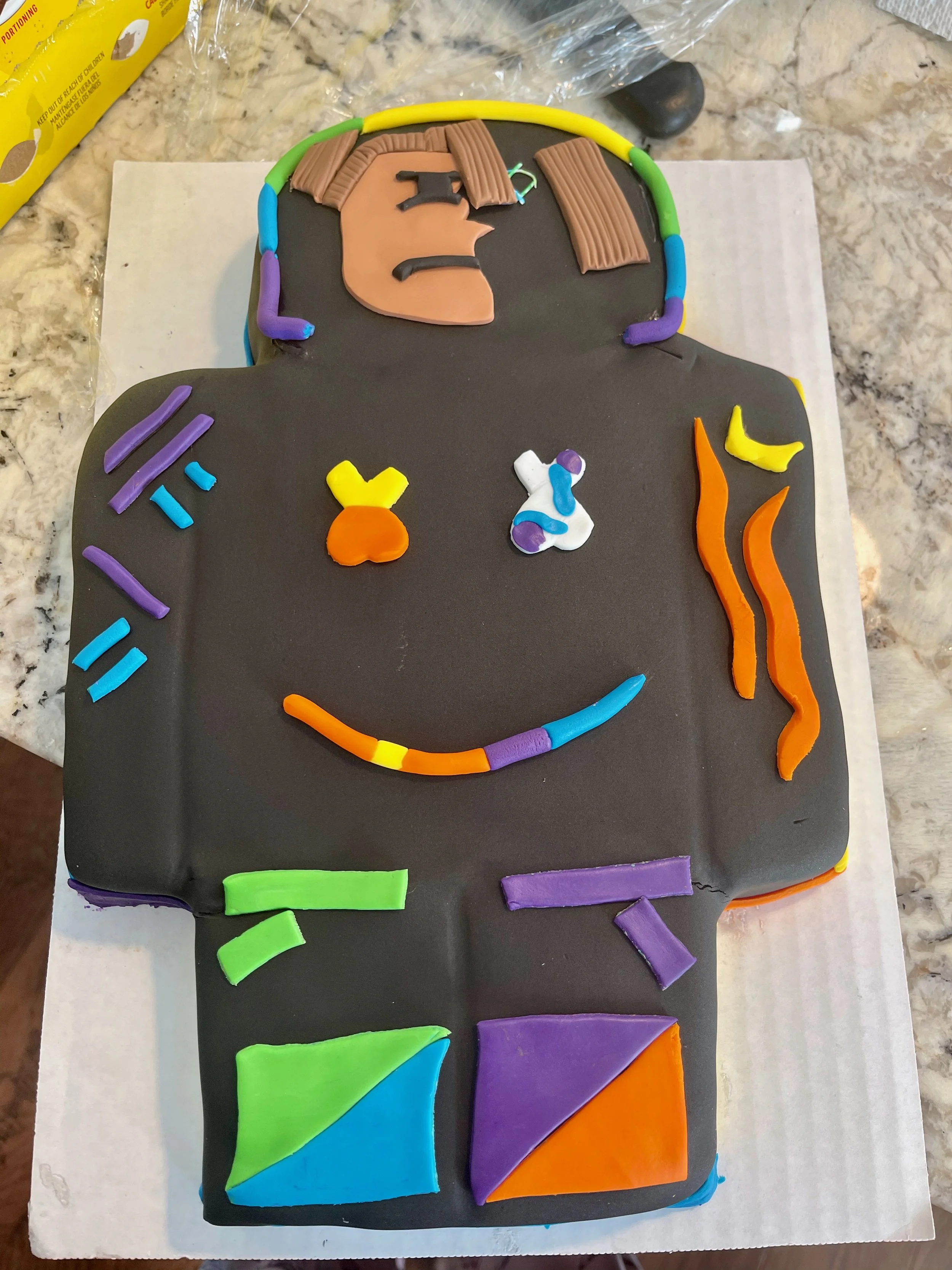 Fortnight action figure cake, covered in fondant.
