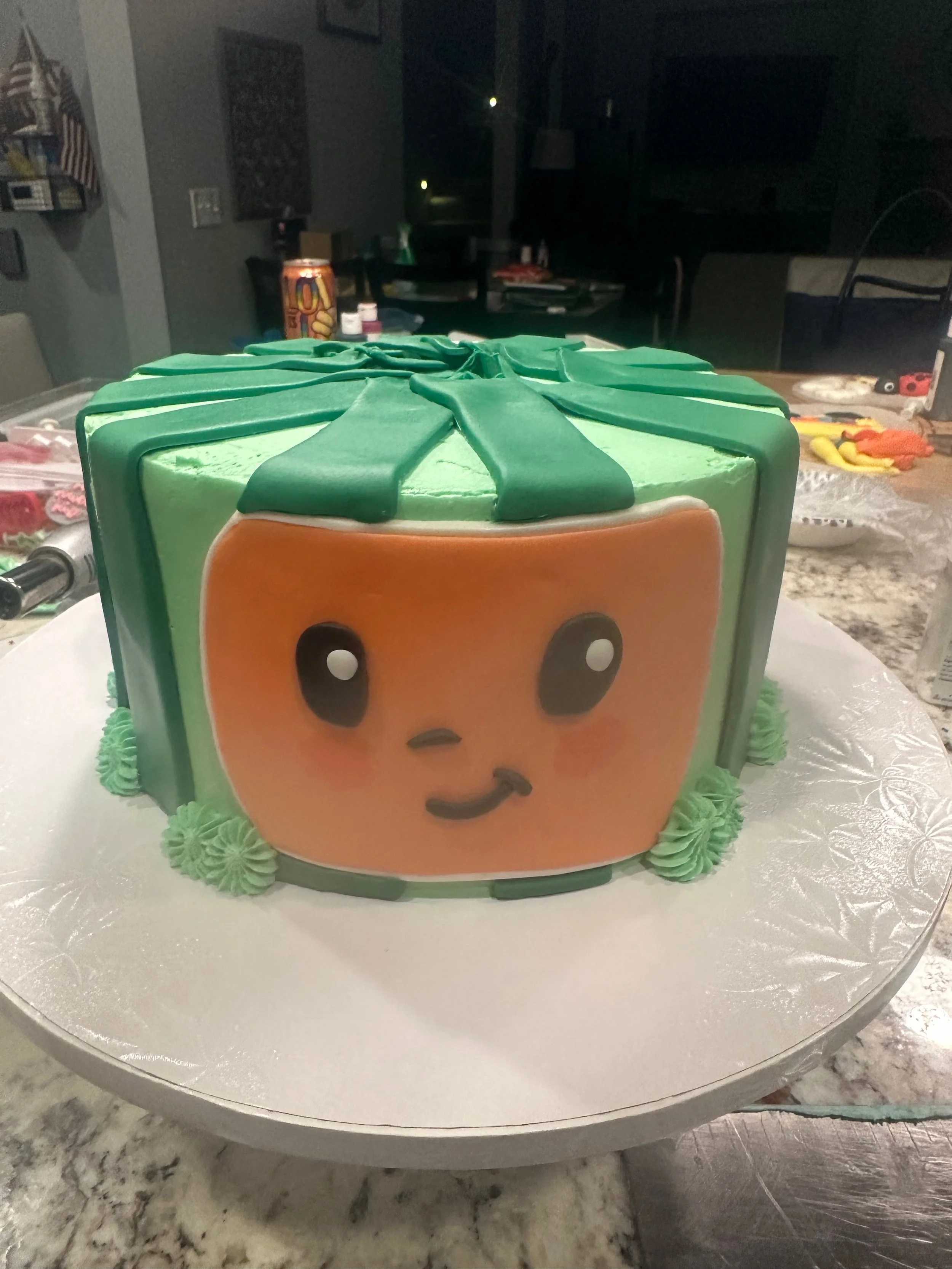 A cake decorated to look like cocomelon.