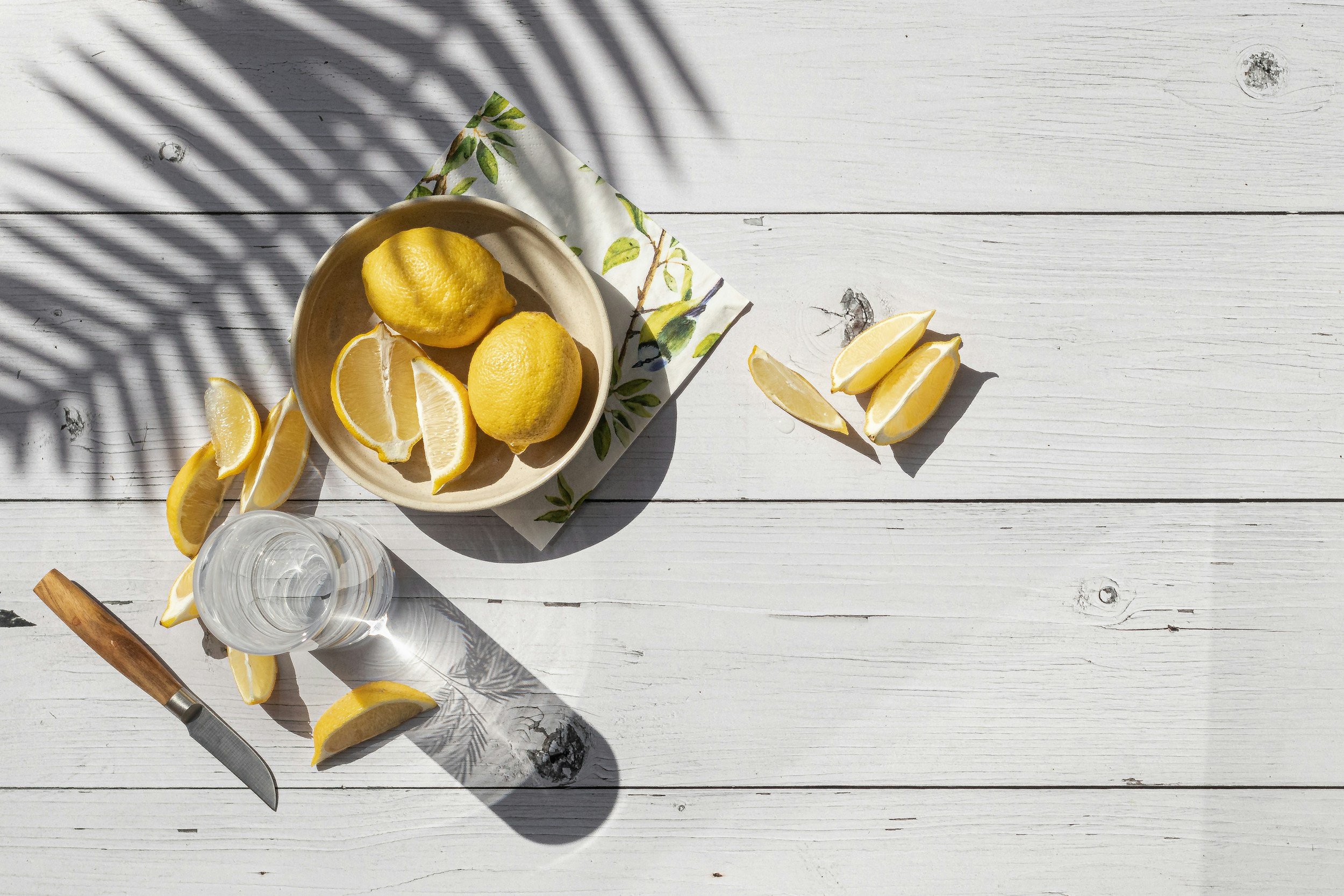 Lemons in Bowl with Water on Table