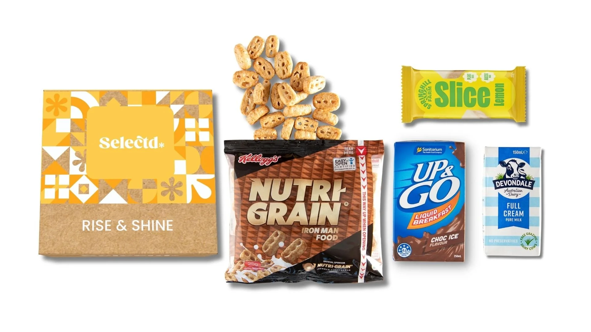 Assorted breakfast items including cereal, nuts, crackers, lemon snack bar, chocolate drink, creamy milk carton, and coffee creamer.