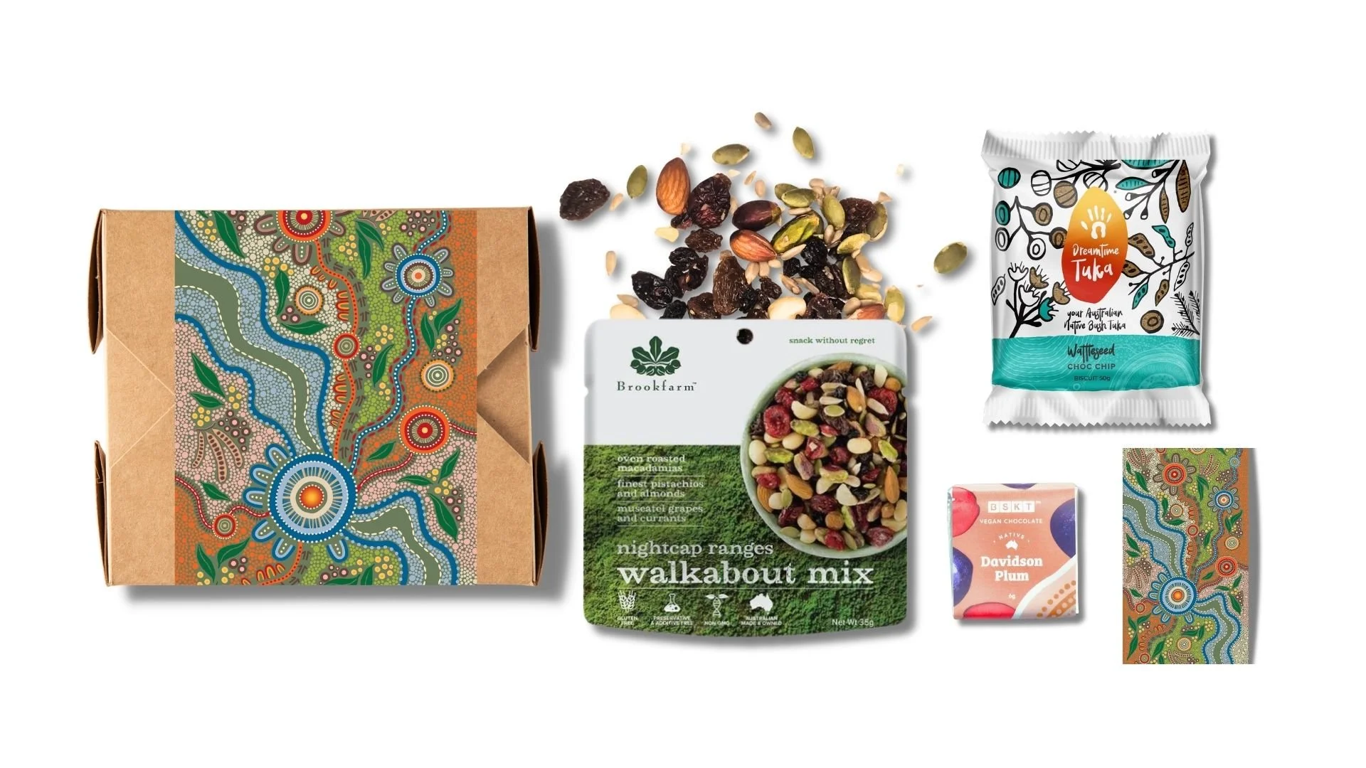 Assortment of Australian-themed snacks including a decorative box, a bag of walkabout mix with dried fruits and nuts, a packet of chick chips, vegan chocolate bar, and a small patterned package, all arranged on a white background.