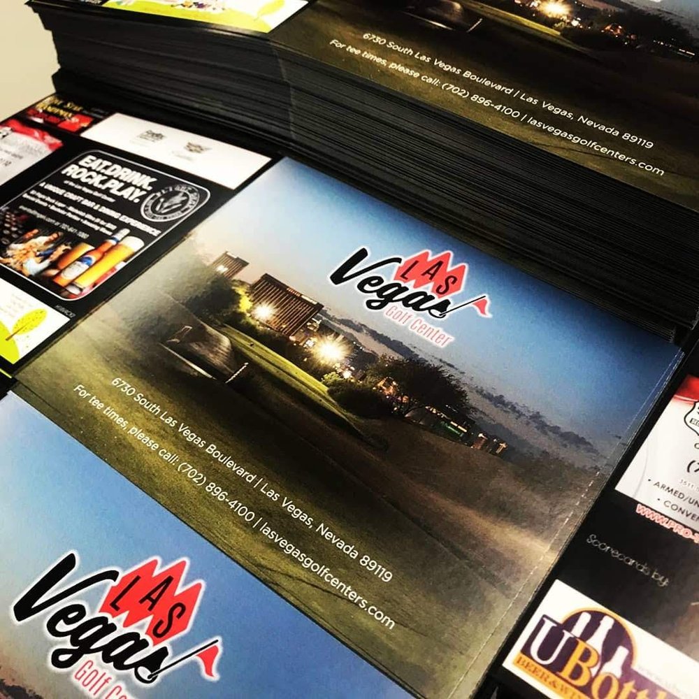 Deep stacks of printed scorecards awaiting shipment