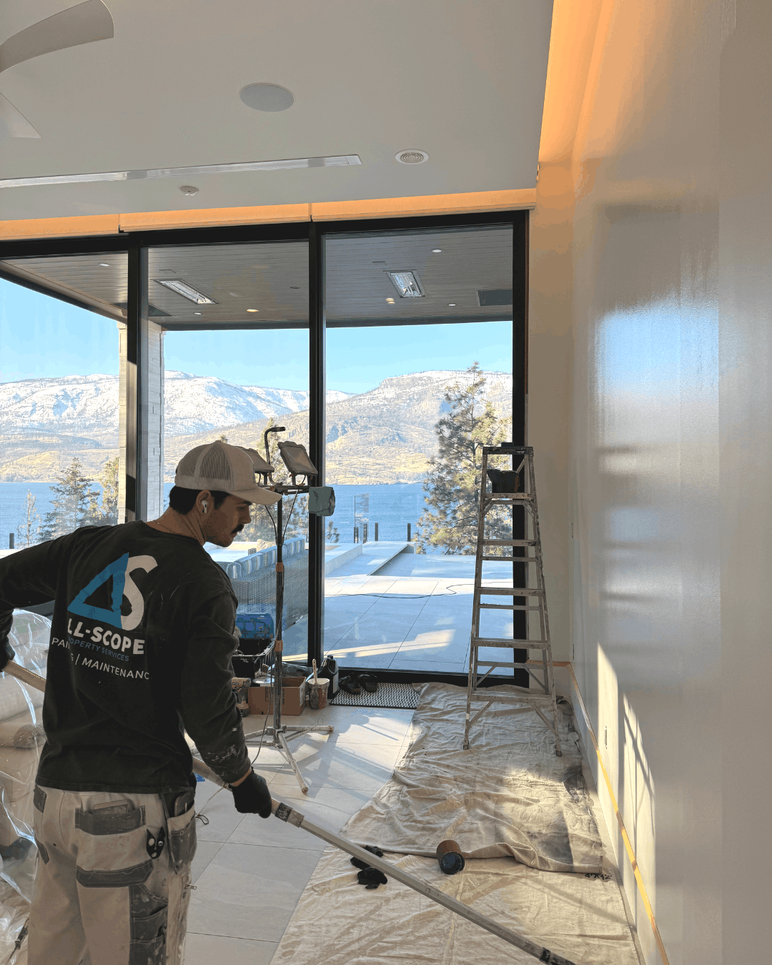 Expert painting interior wall in Kelowna with view of Okanagan lake