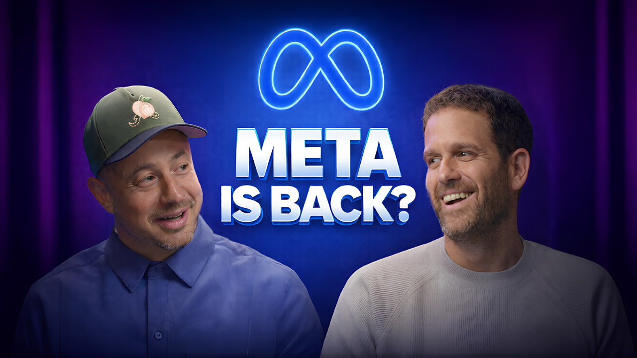 Two men smiling and talking in front of a neon sign that says "Meta is back?" with the Meta logo above.