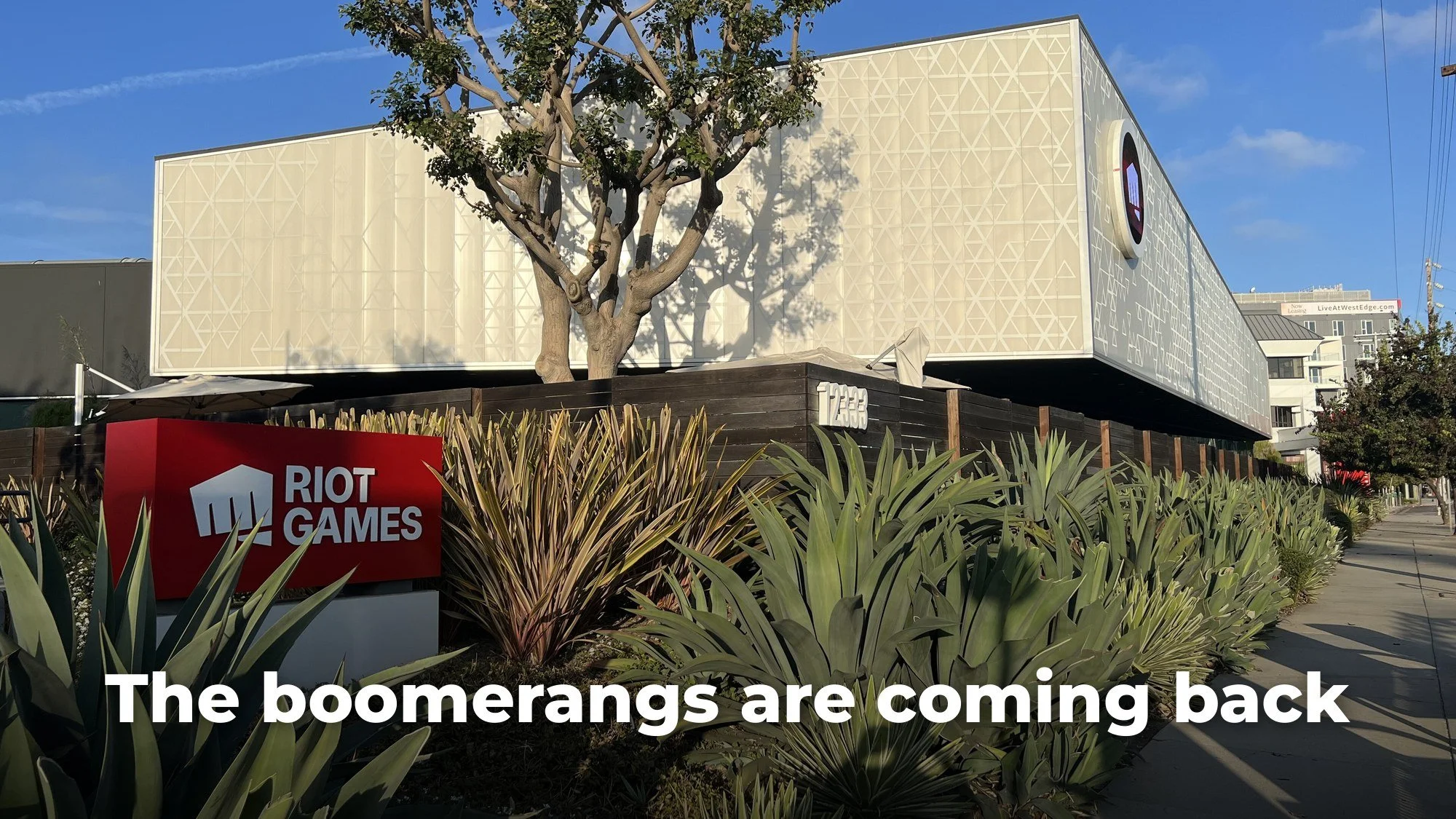 Riot Games headquarters building in Los Angeles with the Riot Games sign, with the text "The boomerangs are coming back"