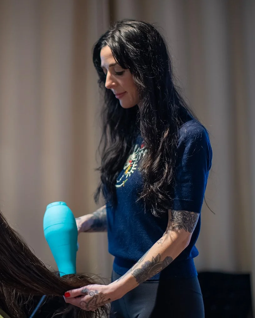 Hannah Smothers (Dyedarlin) blow-drying a person's long brown hair.