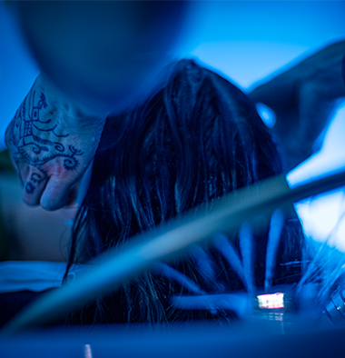 Close-up of a person receiving Japanese Head Spa treatment in a blue-lit environment.