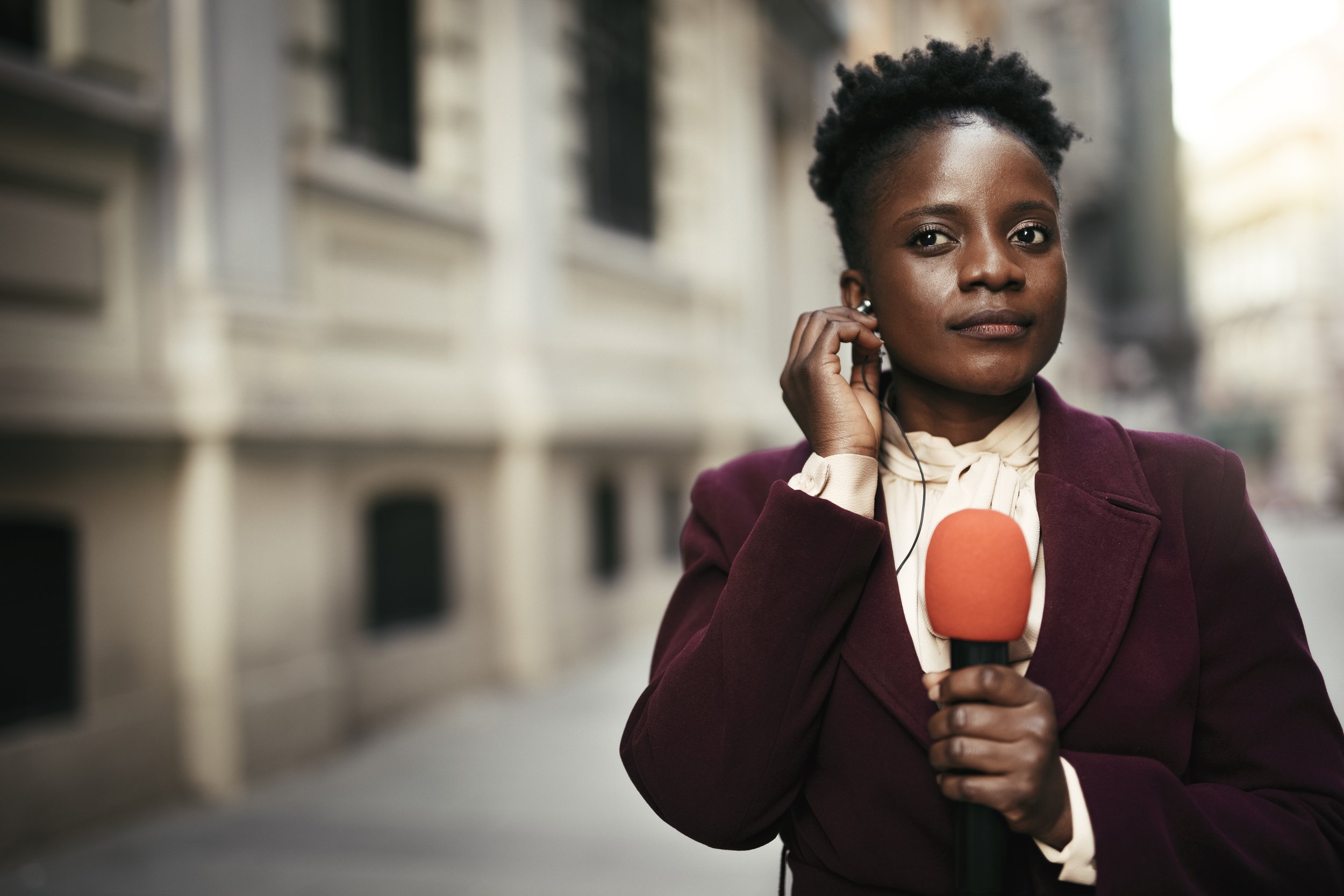 Woman preparing for a broadcast with a confident expression.