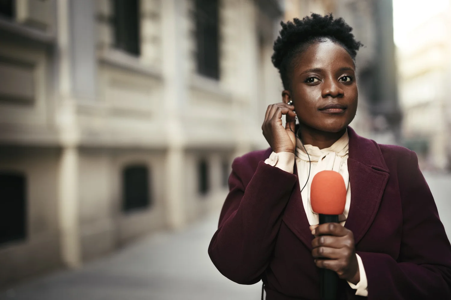 Woman preparing for a broadcast with a confident expression.