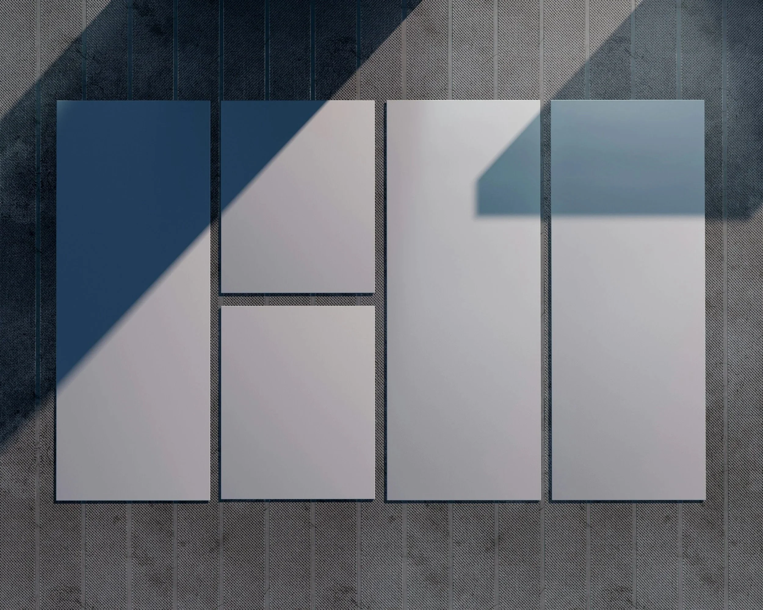 Four white rectangular and one square panels arranged on a textured gray surface, with a shadow cast across them.