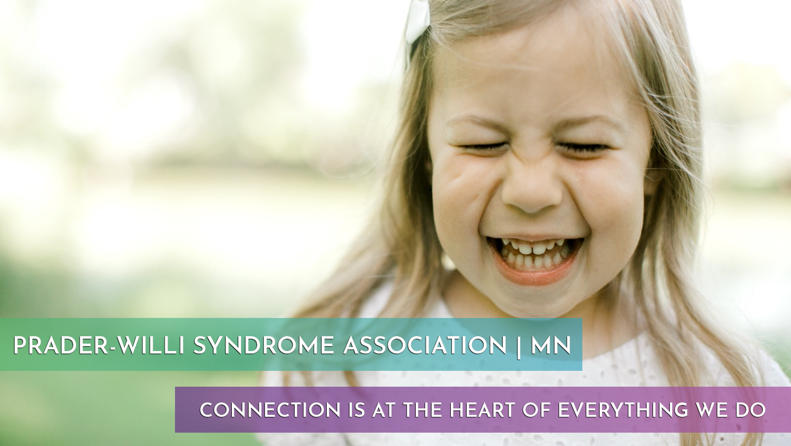 a little girl with prader willi syndrome smiling
