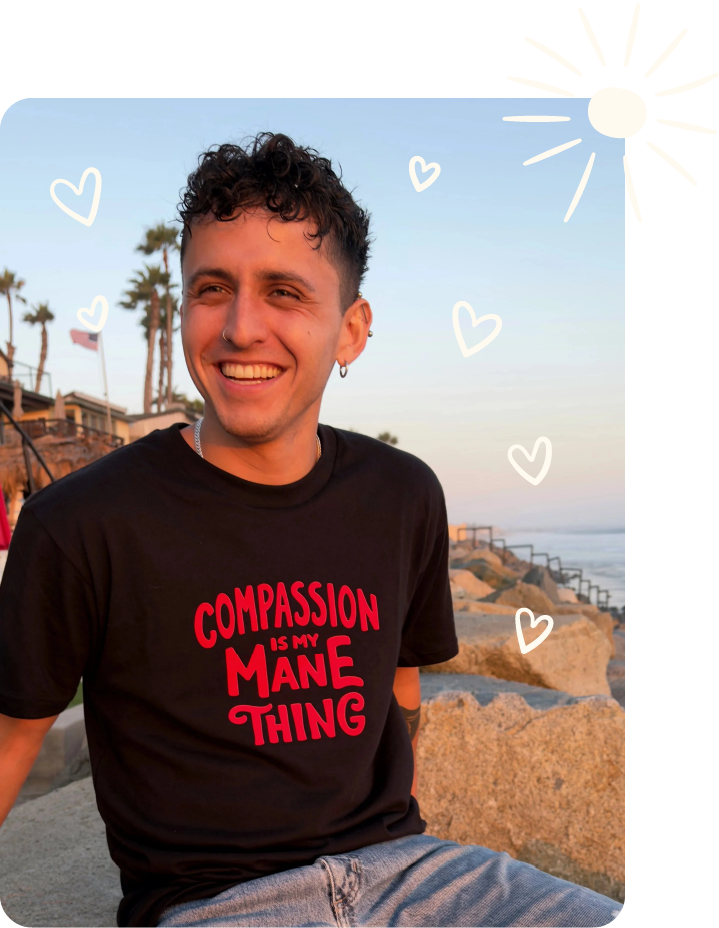 Image of person wearing a shirt that reads, "Compassion is my mane thing." Several heart doodles and a sun doodle are included.