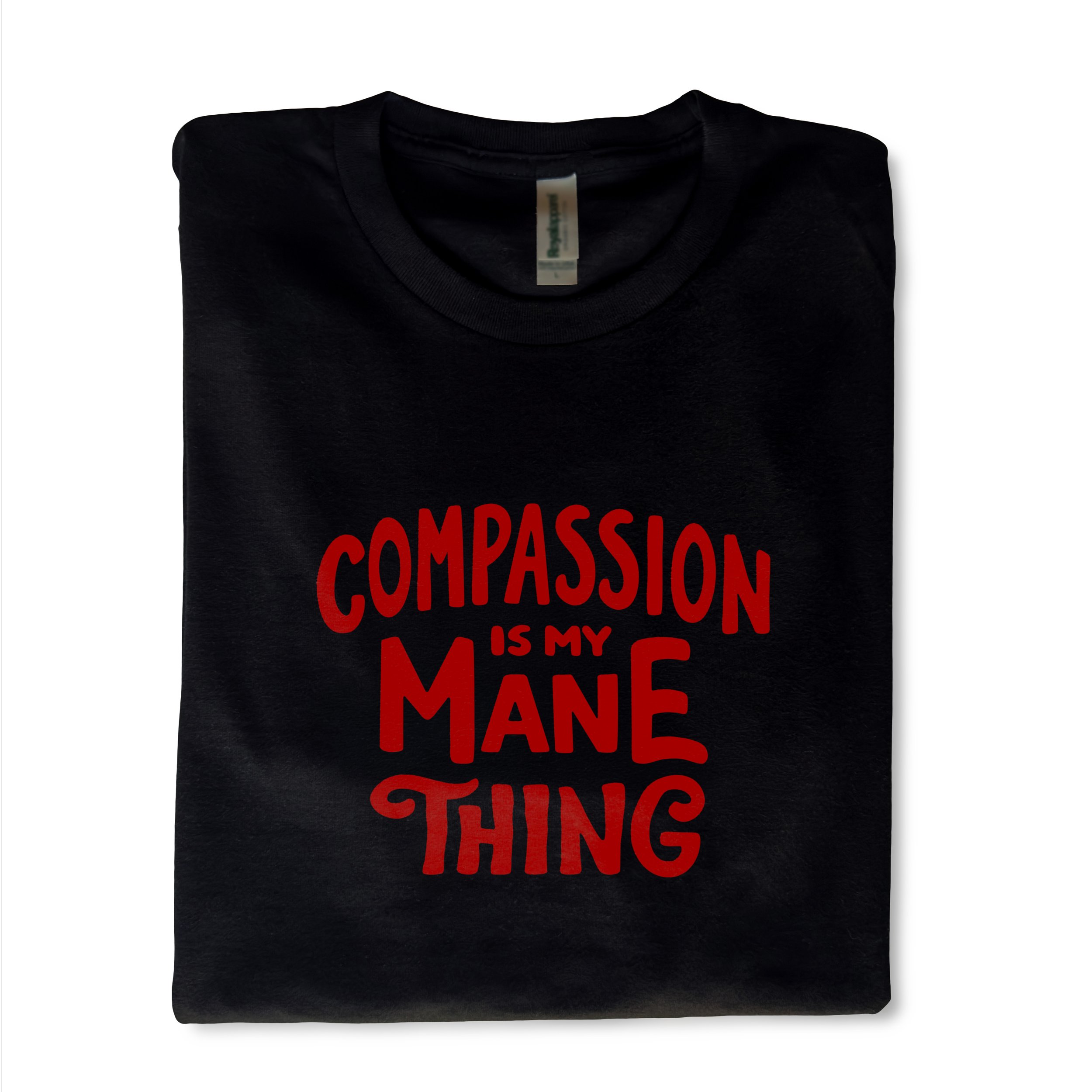 A Image of a black t-shirt with a message that reads: Compassion is my mane thing
