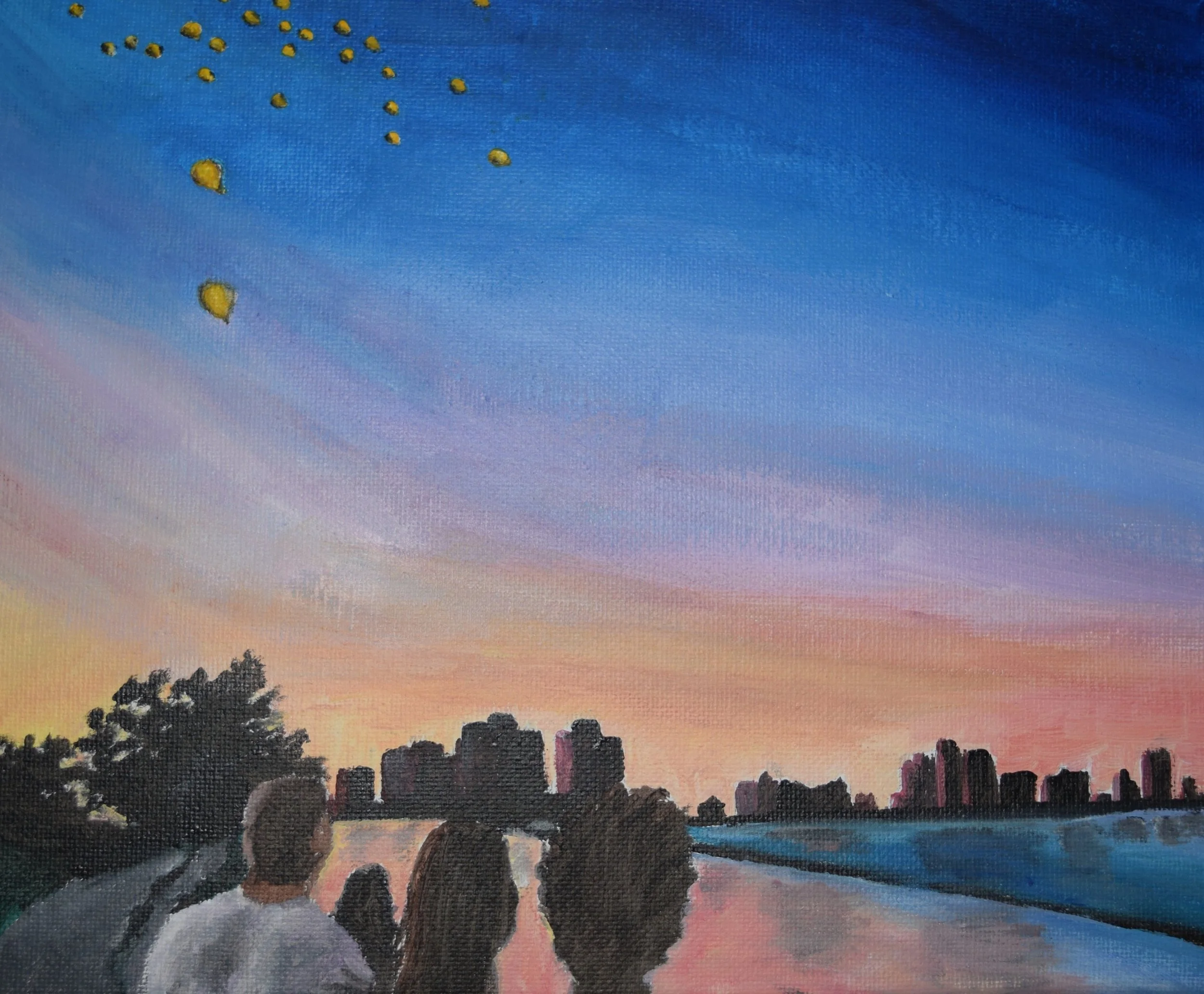 Painting of a sunset over water with a city skyline, three people in the foreground watching the release of yellow balloons into the sky.