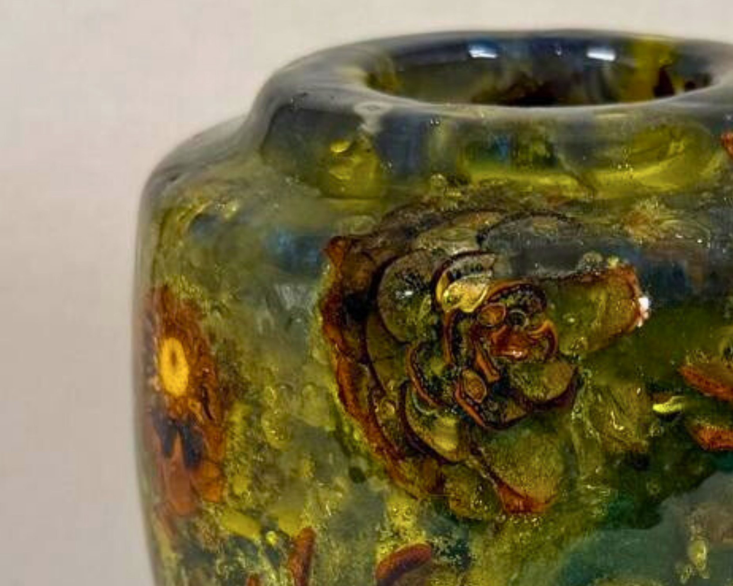 Close view of the vessel’s upper shoulder and rim, highlighting suspended pine cone forms within translucent green and blue epoxy.