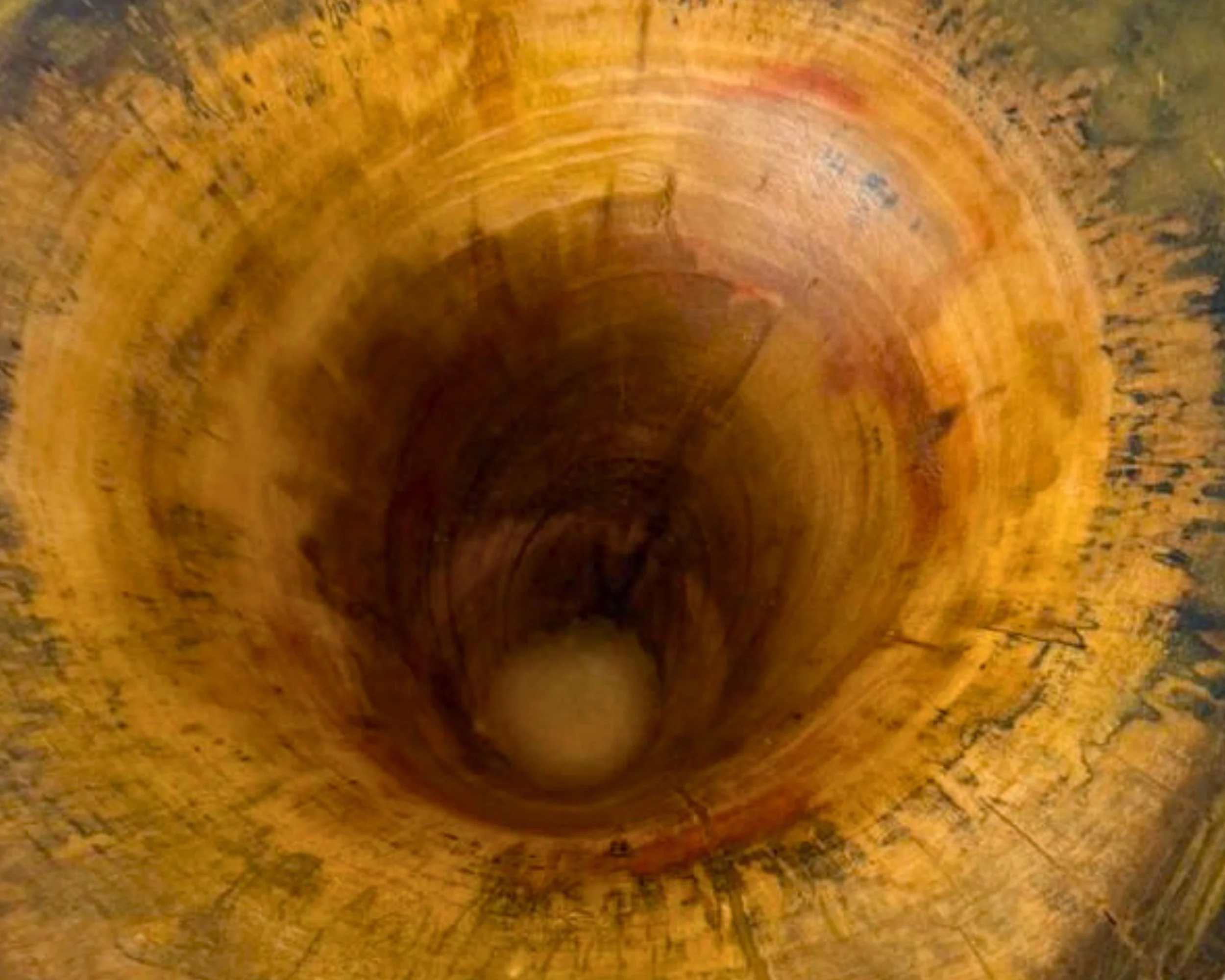 Interior depth view looking down into the vessel, showing warm maple tones, figure, and smooth turning lines.