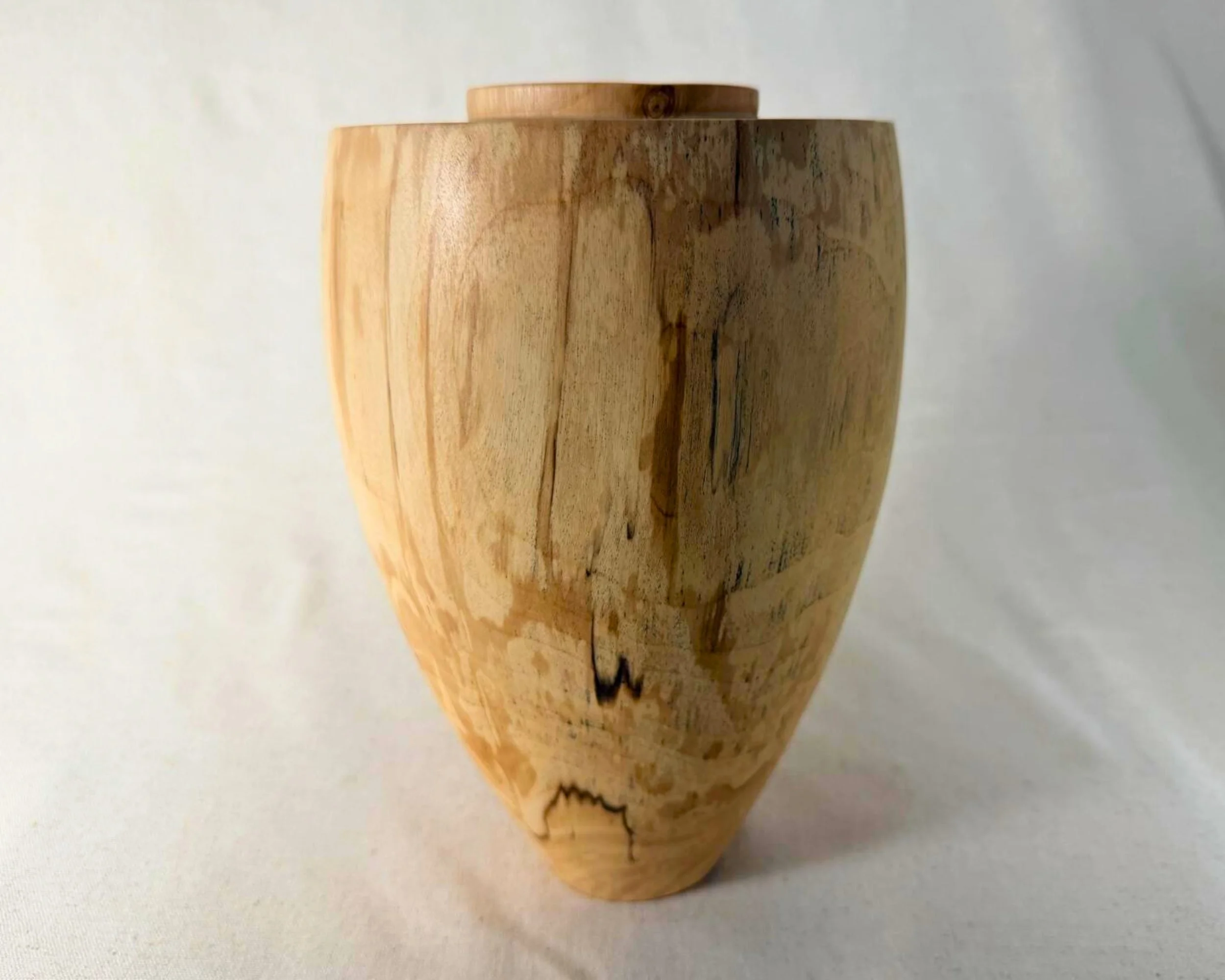 Spalted river birch vessel three-quarter view showing mottled spalting patterns and clean, sculptural proportions.