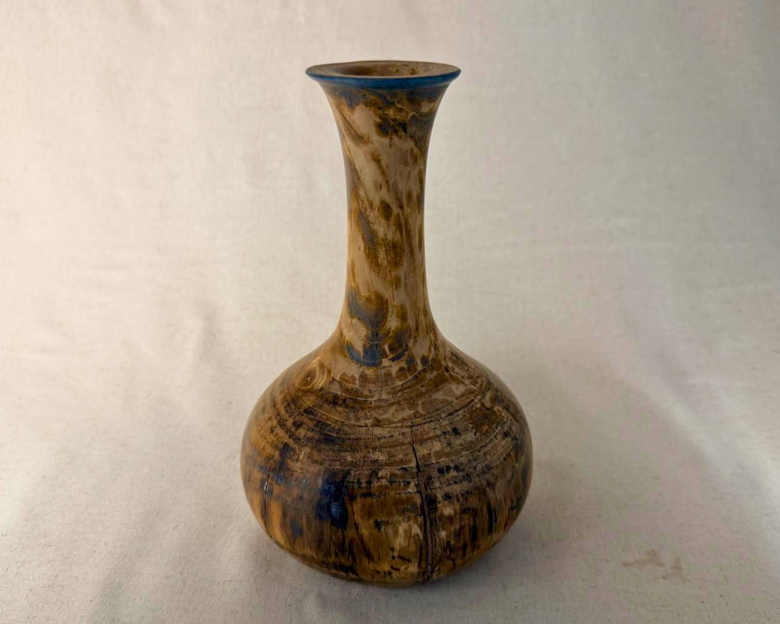 Reclaimed maple vase with subtle blue epoxy band at the rim, tall hand-turned wood vessel on neutral backdrop.