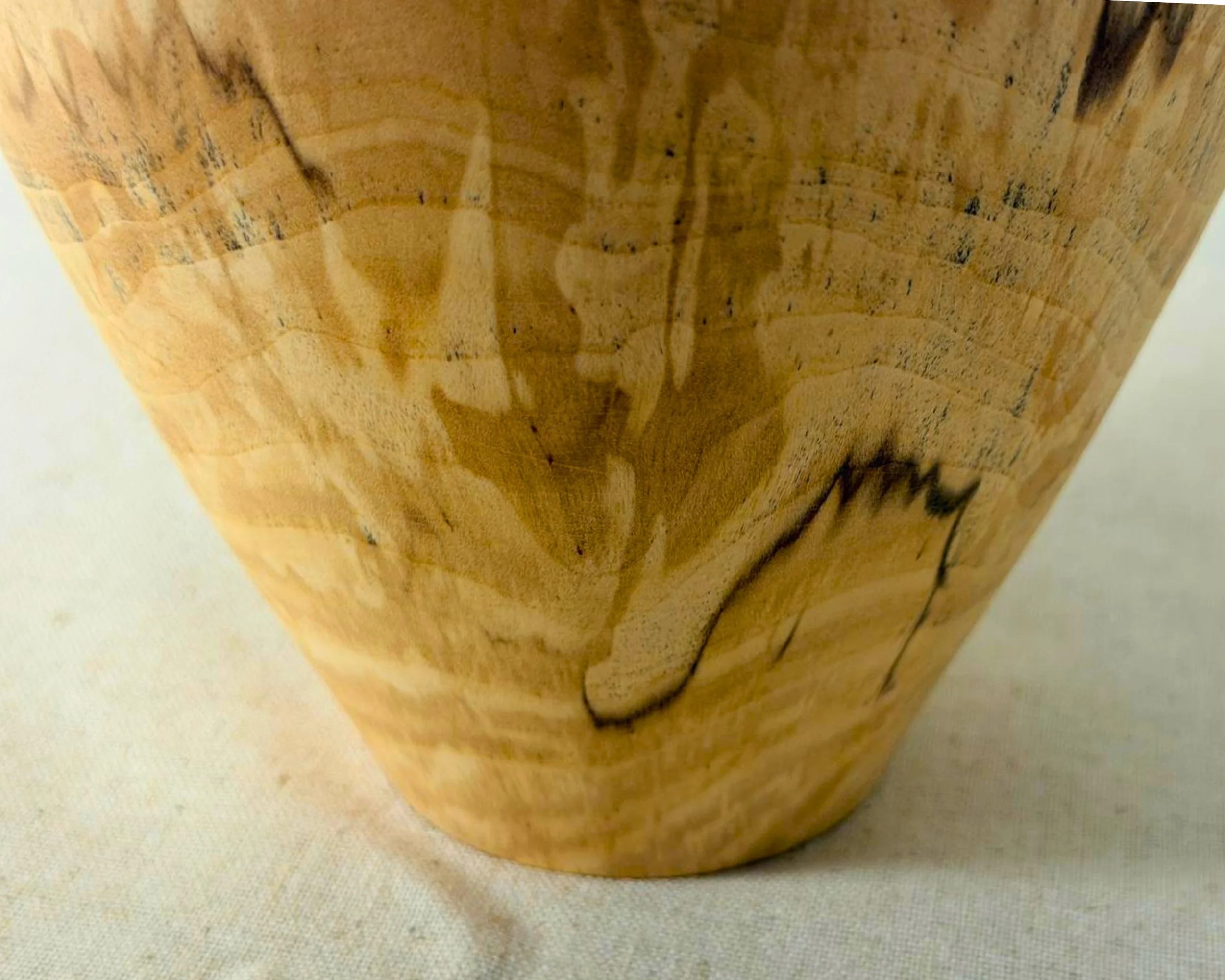 Lower-body detail of spalted river birch vessel showing tapered base, spalting patterns, and natural dark spalt lines.