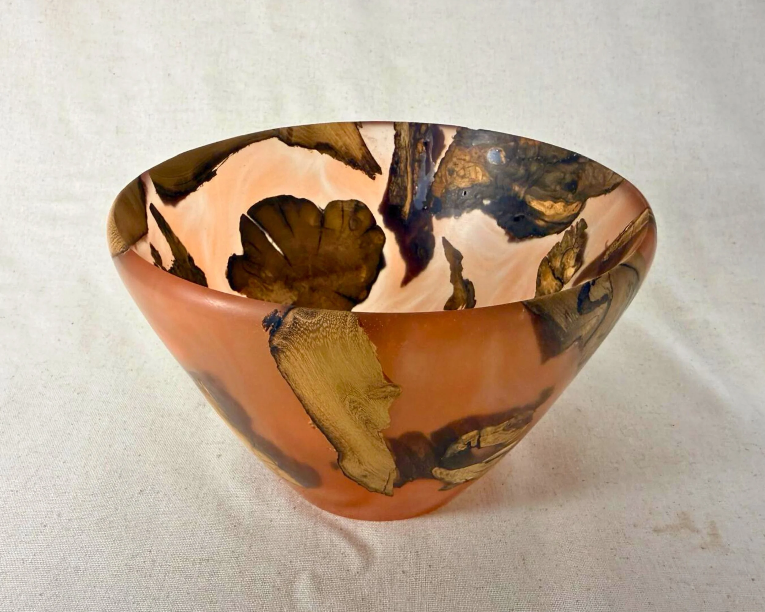 Three-quarter front view of the bowl showing the interior pattern and warm amber translucence.