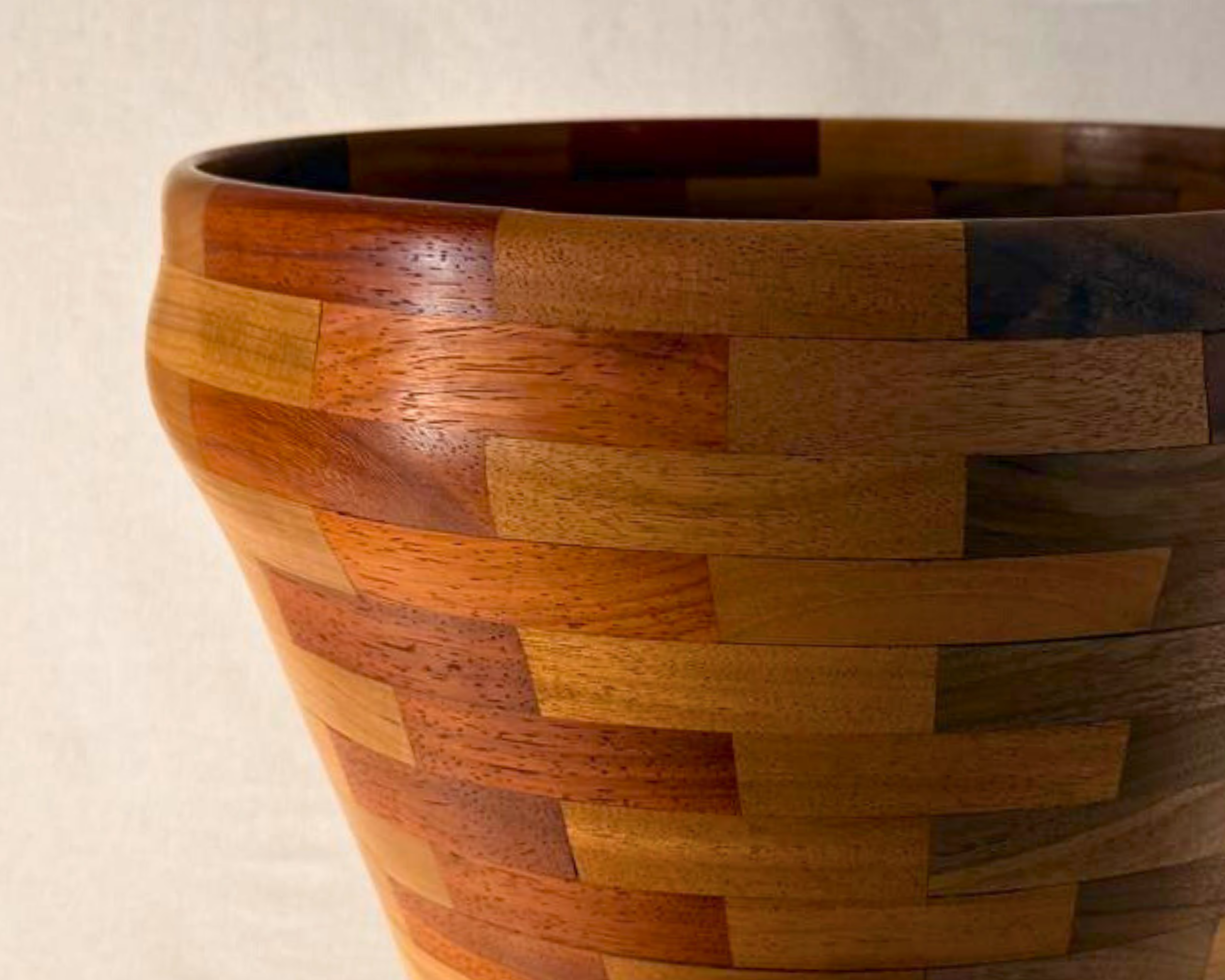 Side close-up of large segmented wood vessel highlighting rim thickness and curved profile.
