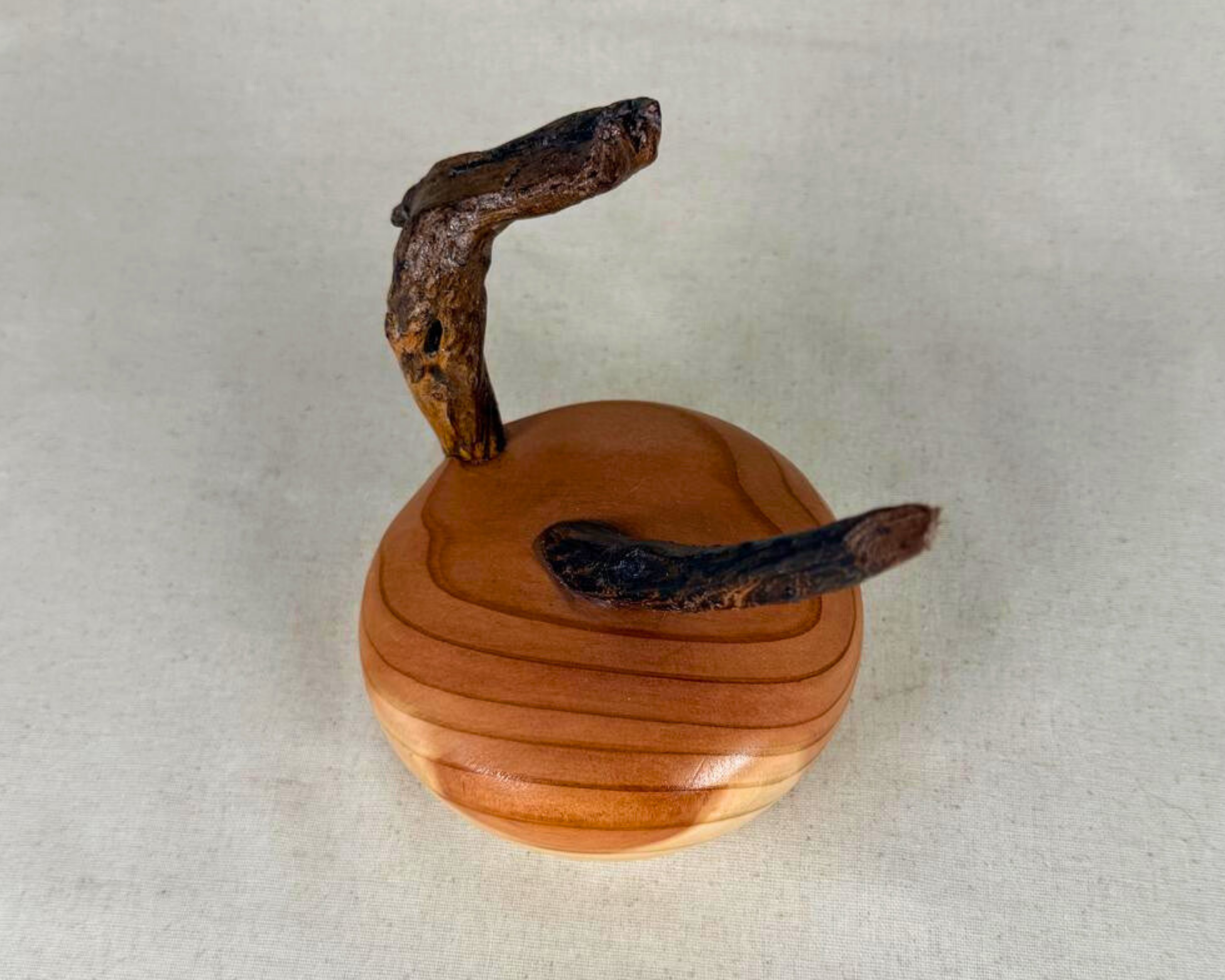 Top view of a sequoia and driftwood sculpture revealing the flowing grain pattern of the turned sequoia base and the placement of two natural driftwood elements.