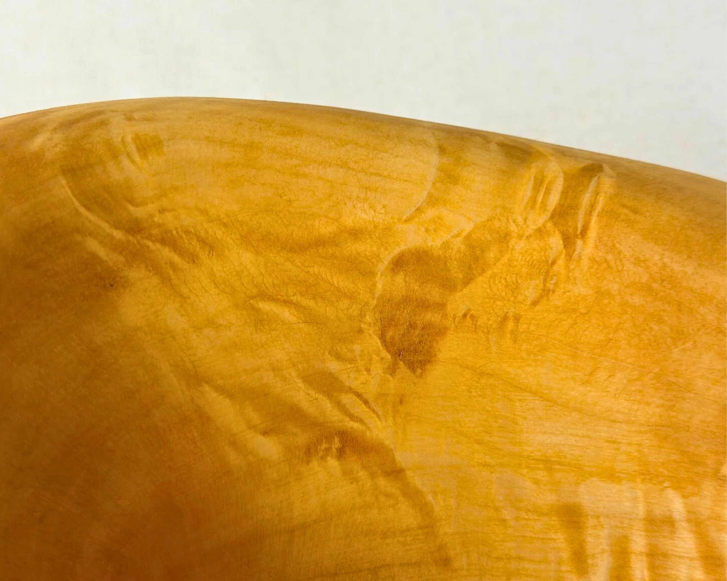 Detail view of reclaimed pine surface showing silky sheen and flowing grain pattern.