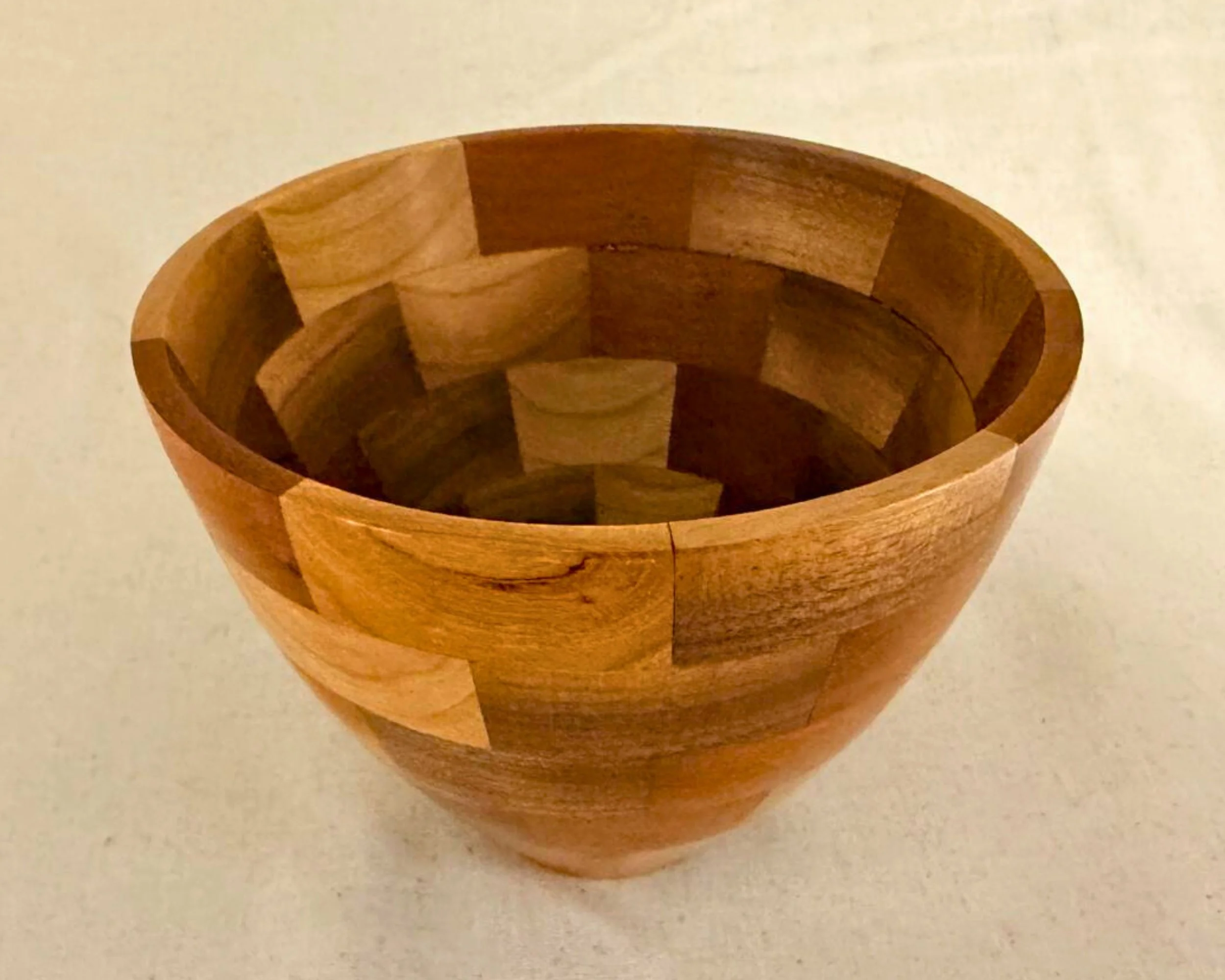 Top view of segmented walnut, padauk, and maple vessel showing interior patchwork geometry.