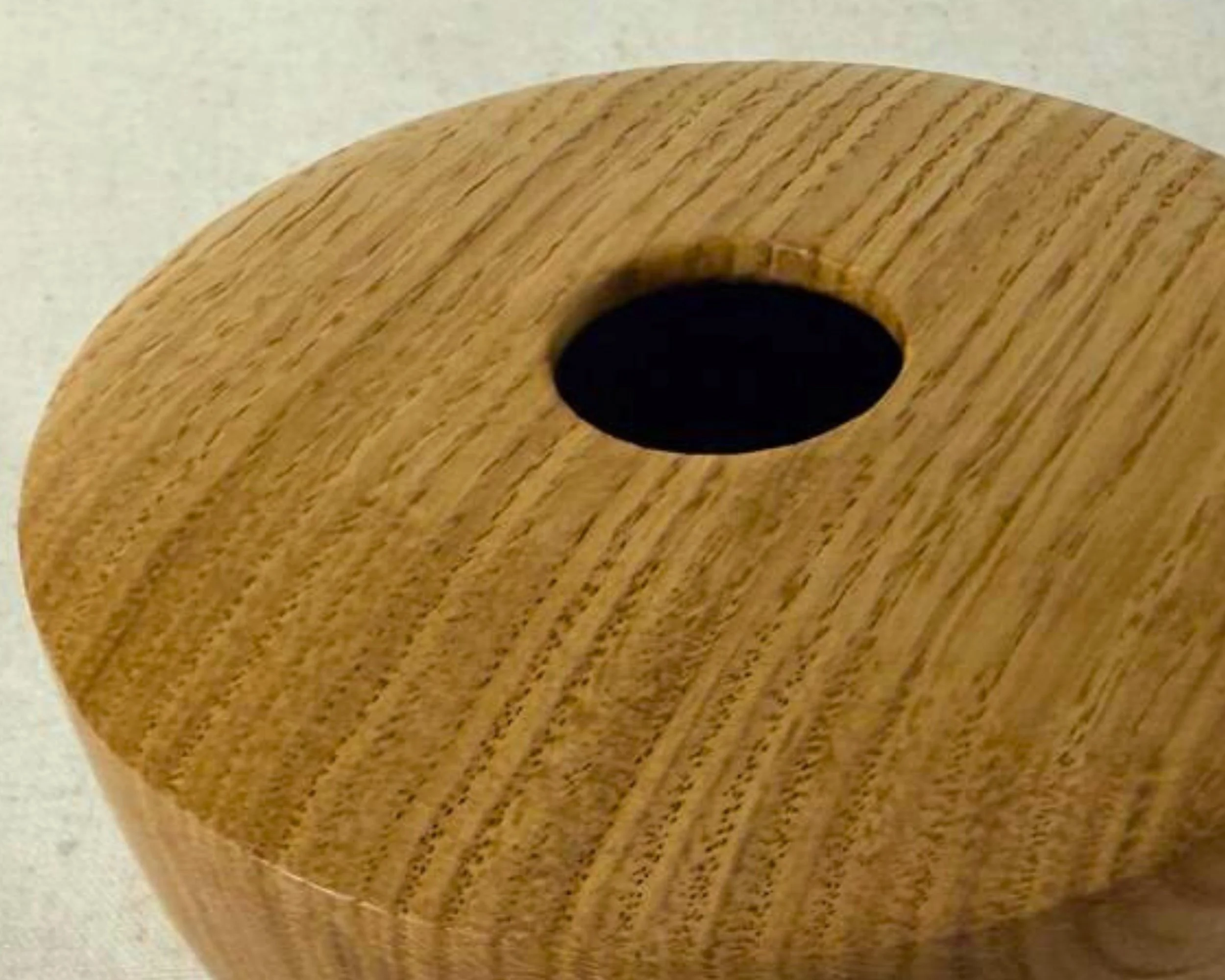 Top view of handturned oak hollow form showing the round opening and straight-grain pattern.