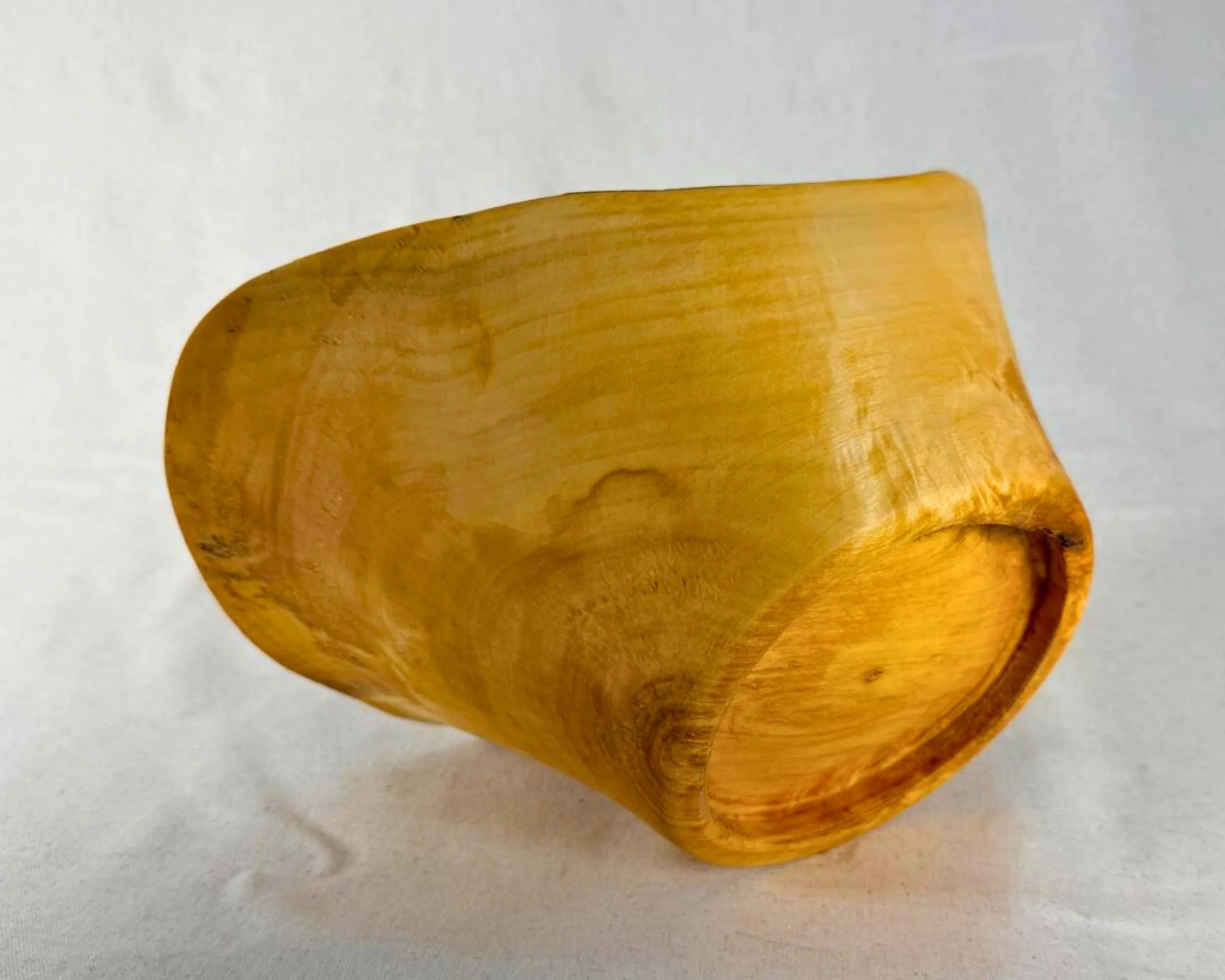 Reclaimed pine vessel tipped to show underside profile and natural edge contour.