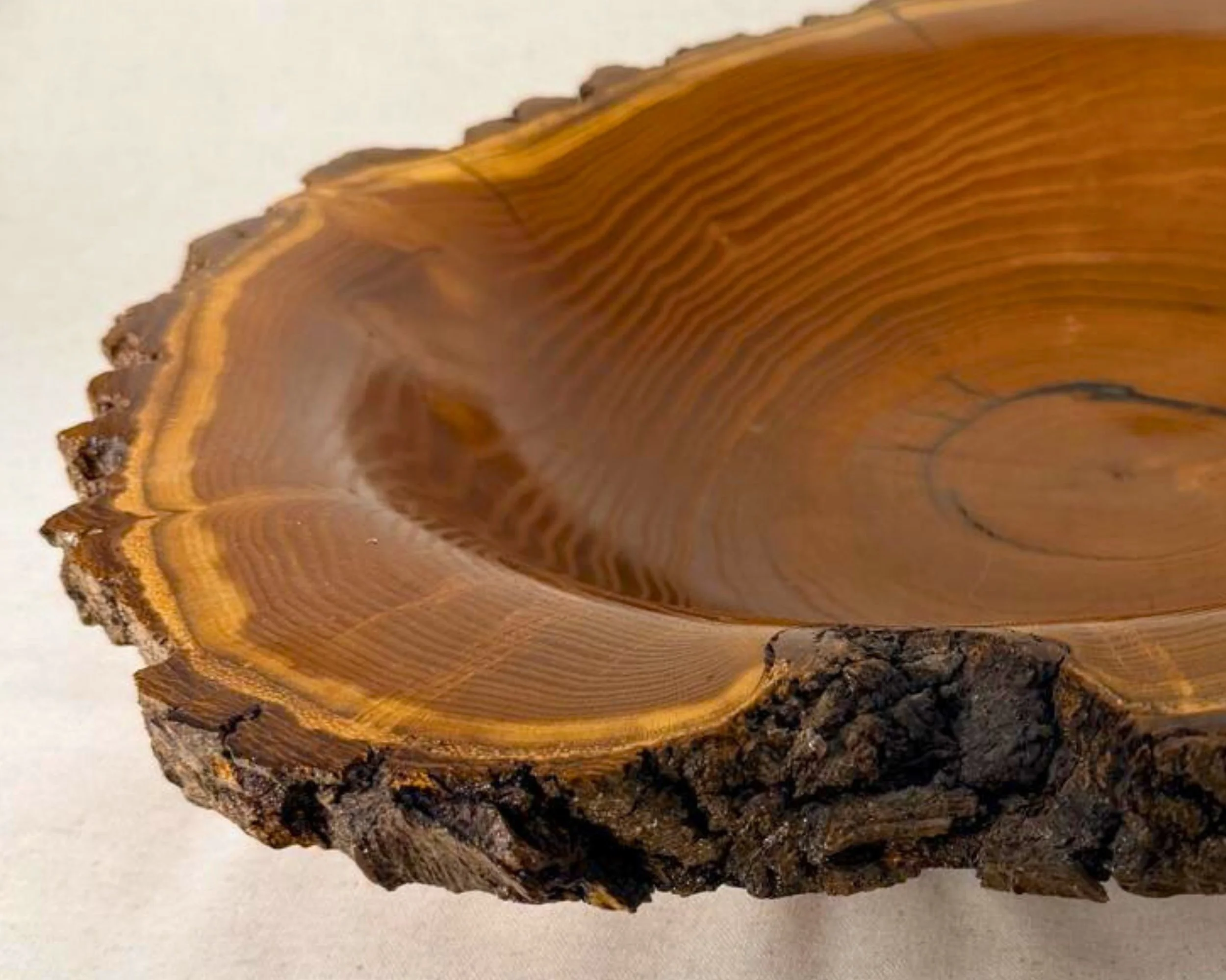 Mulberry live-edge bowl, close-up showing curved interior grain and natural color variation