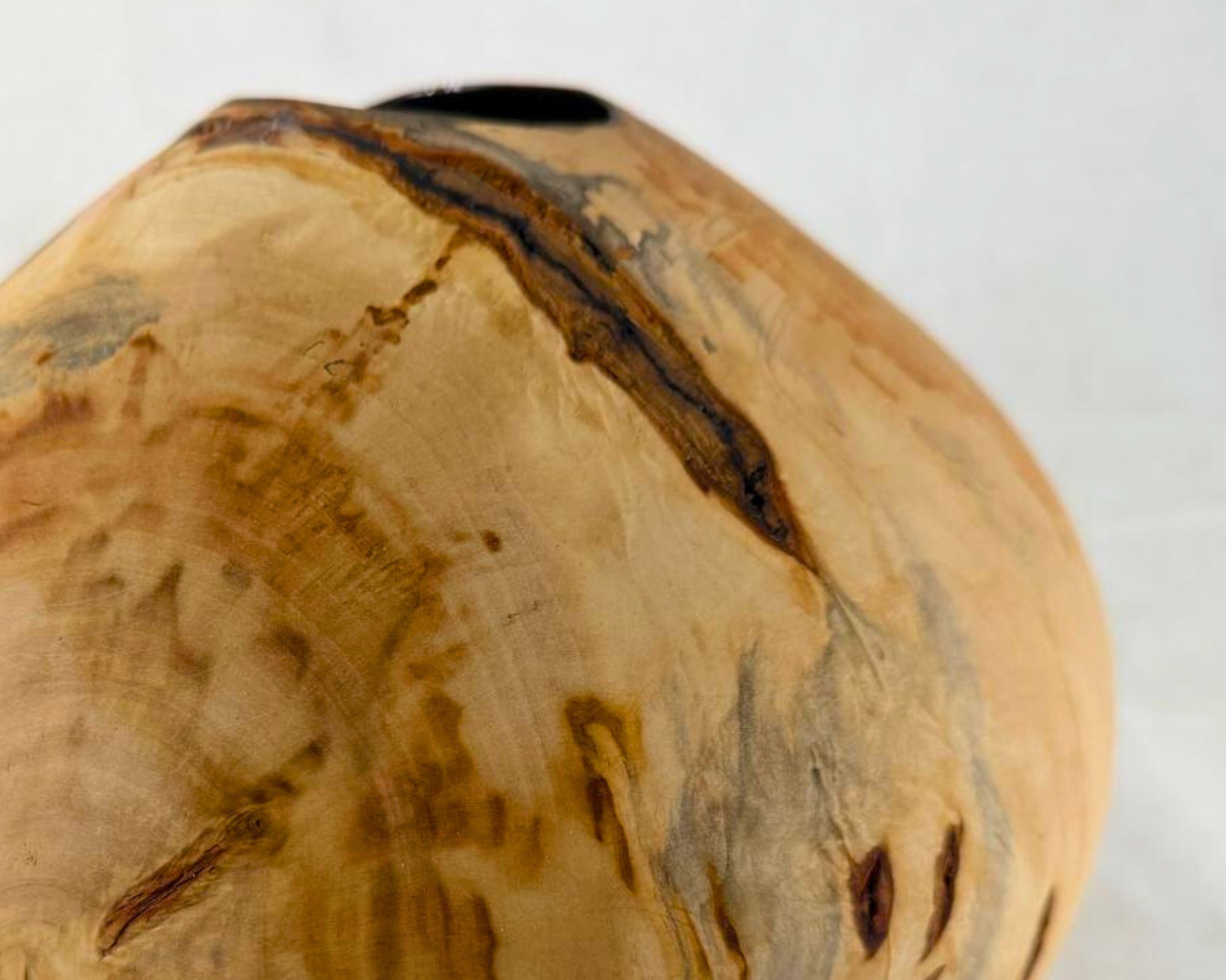 Close-up of reclaimed pine surface showing knots, natural void marks, and gray-blue staining.