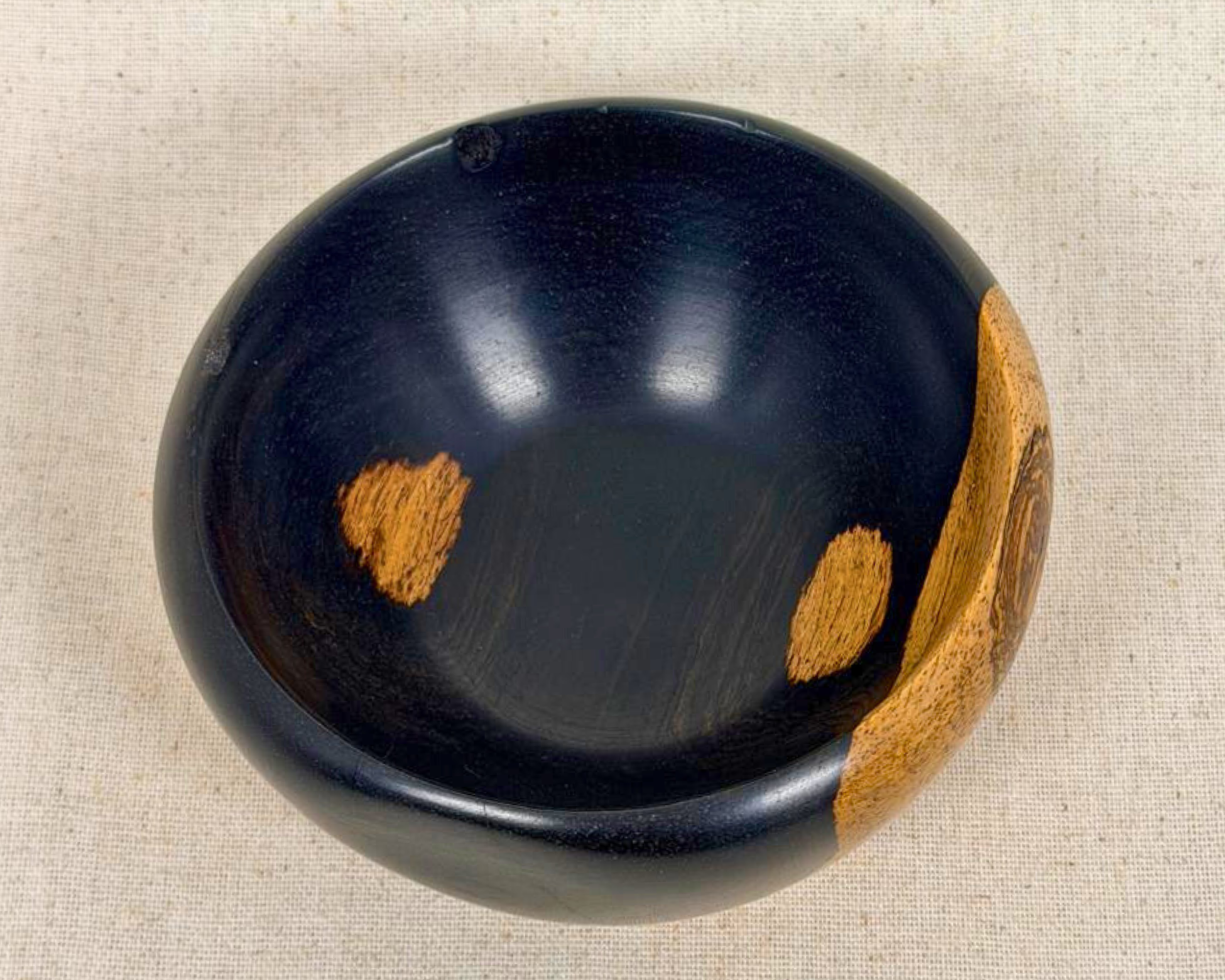 Top-down view of the African Blackwood bowl showing the open interior, rounded rim, and small natural wood inclusions inside.