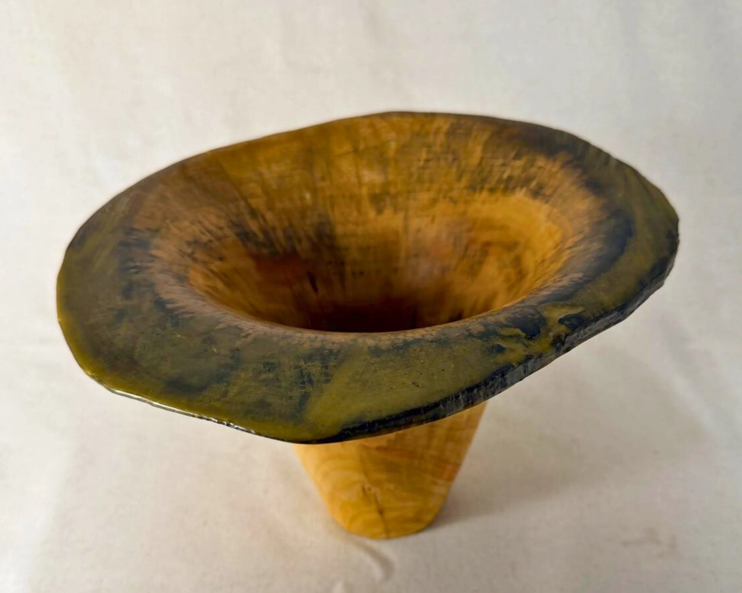 Angled top view highlighting the rim’s organic outline and the epoxy-filled voids around the edge.