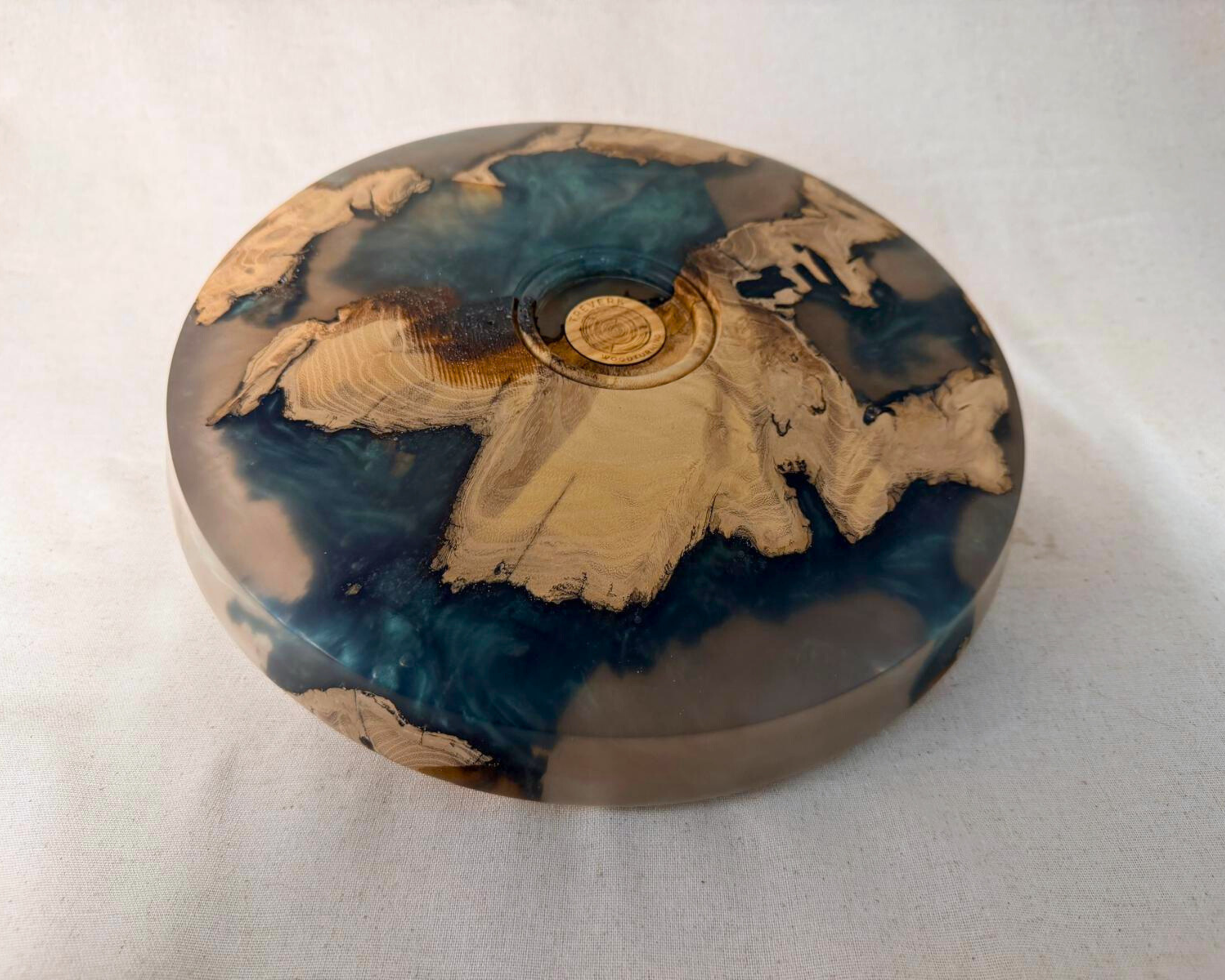 Bottom view of round tree root epoxy platter showing base profile and maker’s mark area.