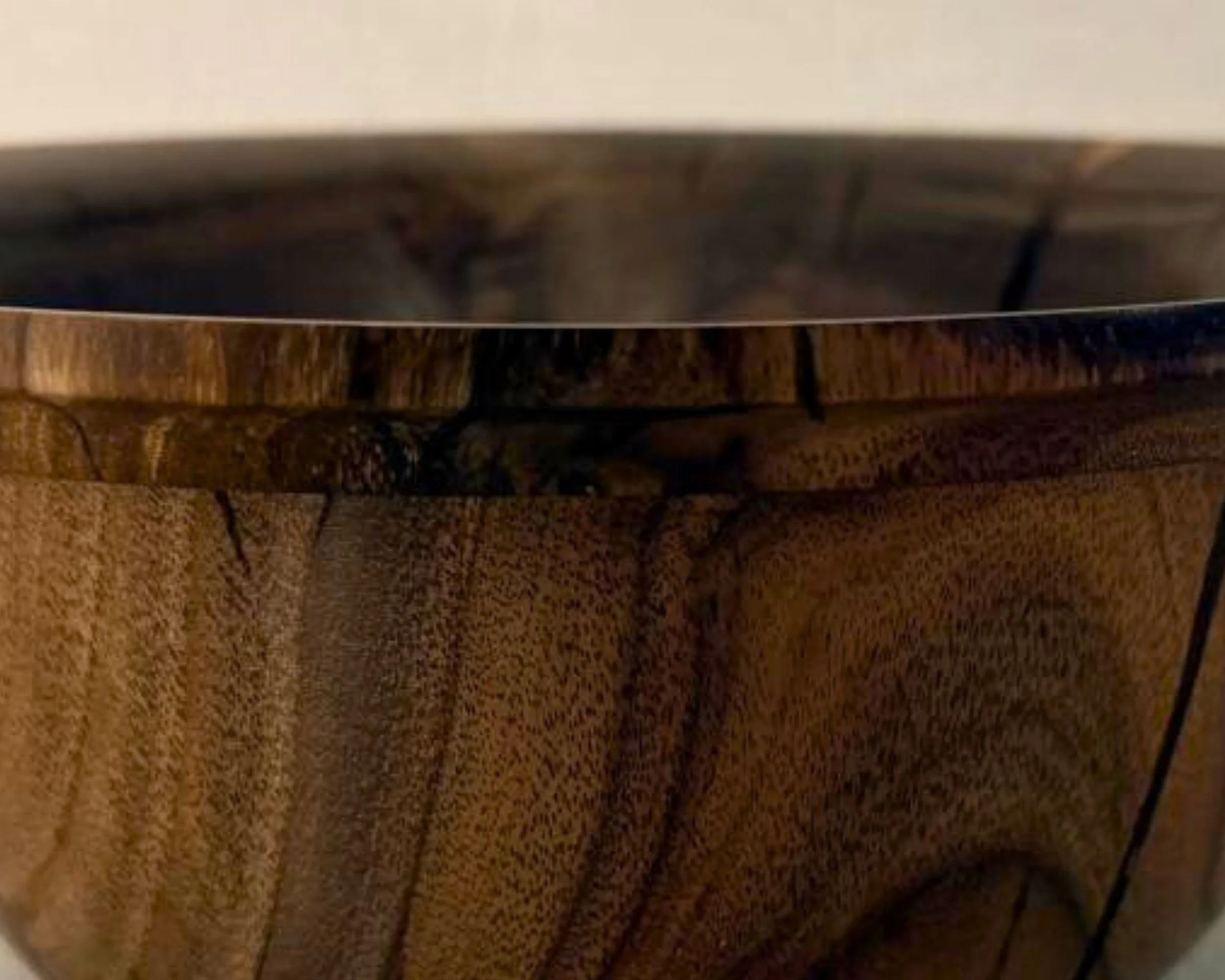 Detail view of claro walnut grain movement with dark contour lines and warm brown tones.