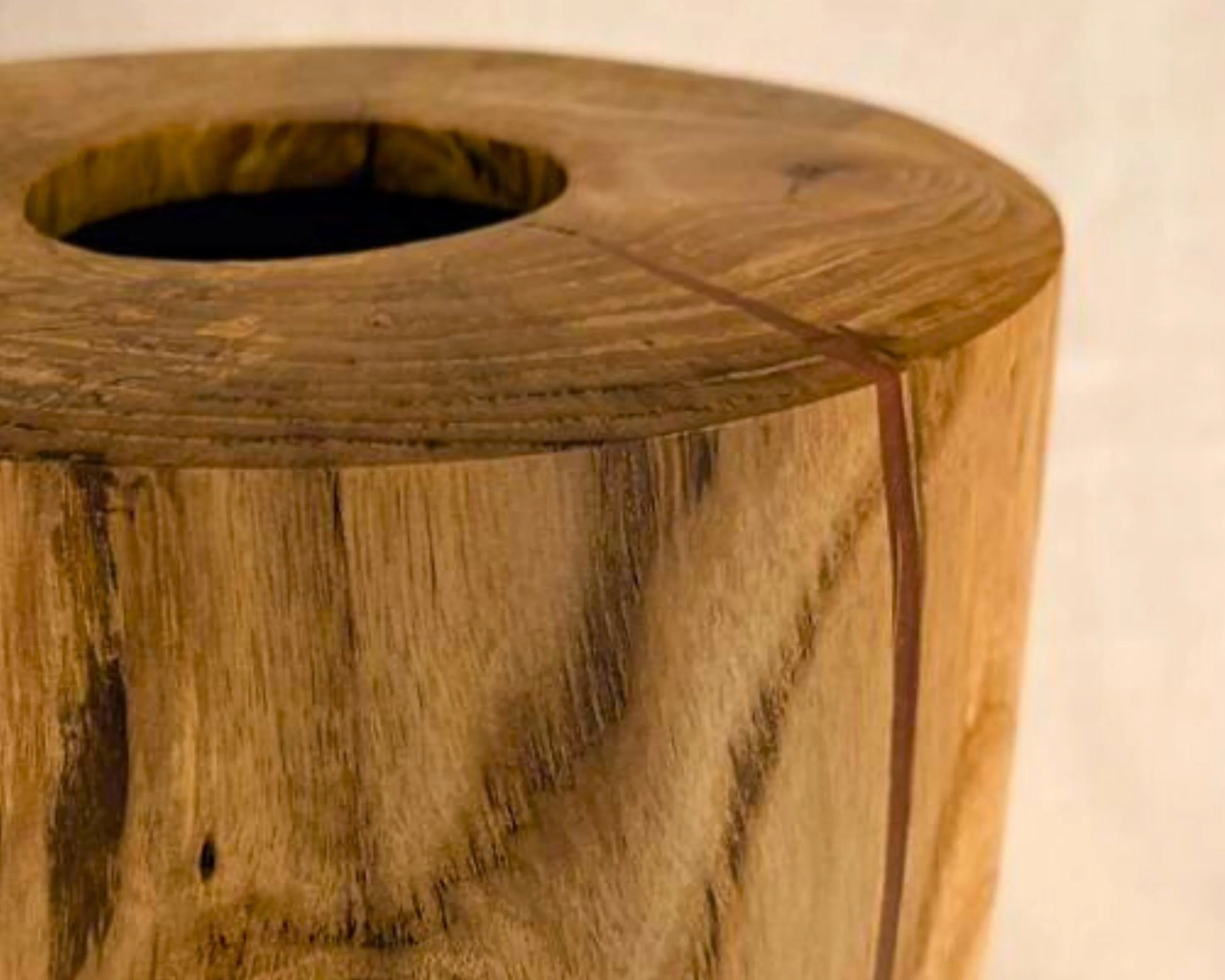 Close-up of neutral epoxy fill line and surrounding maple grain on the vessel’s top edge and side.