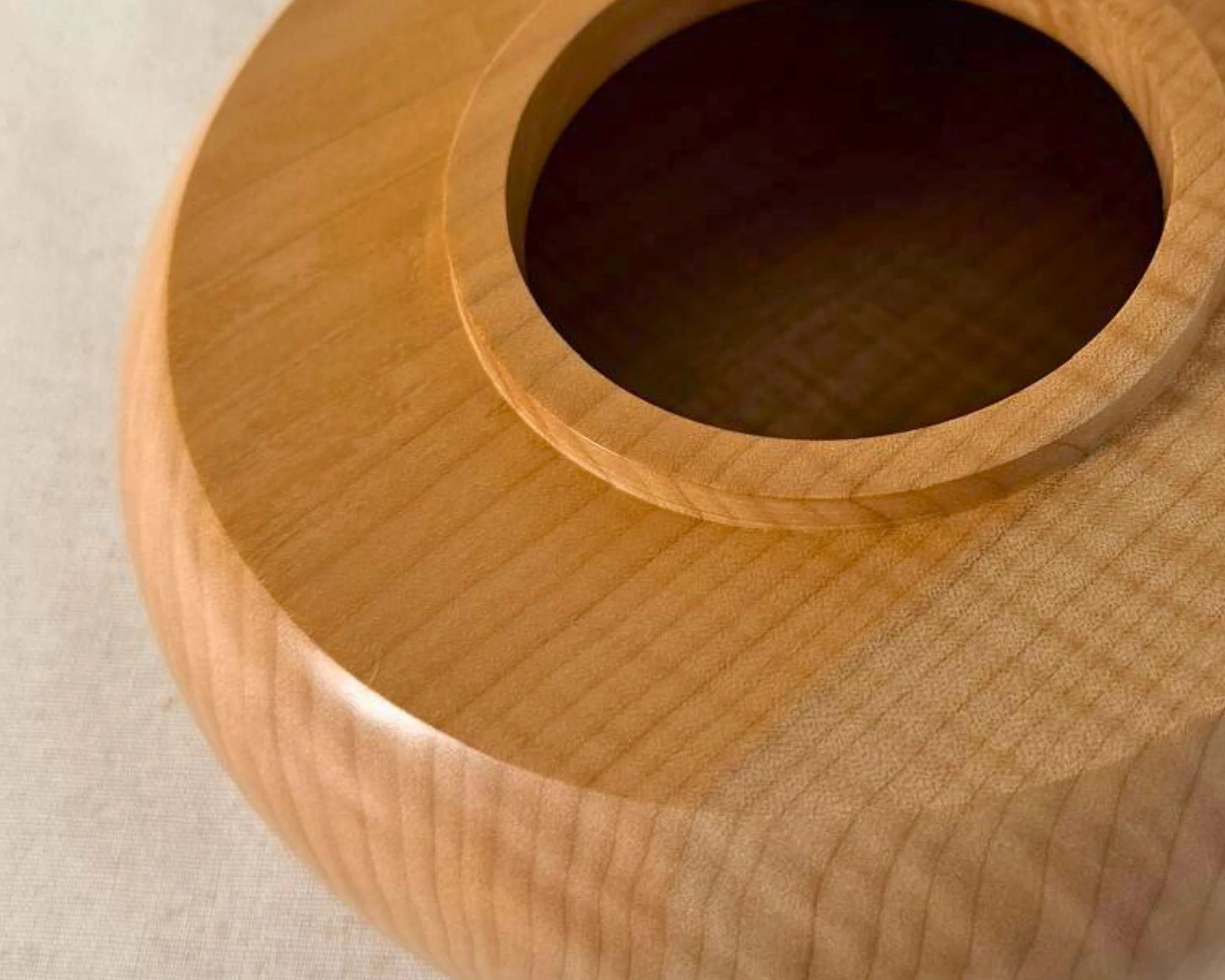 Close-up top view of the maple vessel collar and opening with smooth turned ring detail and clean circular geometry.
