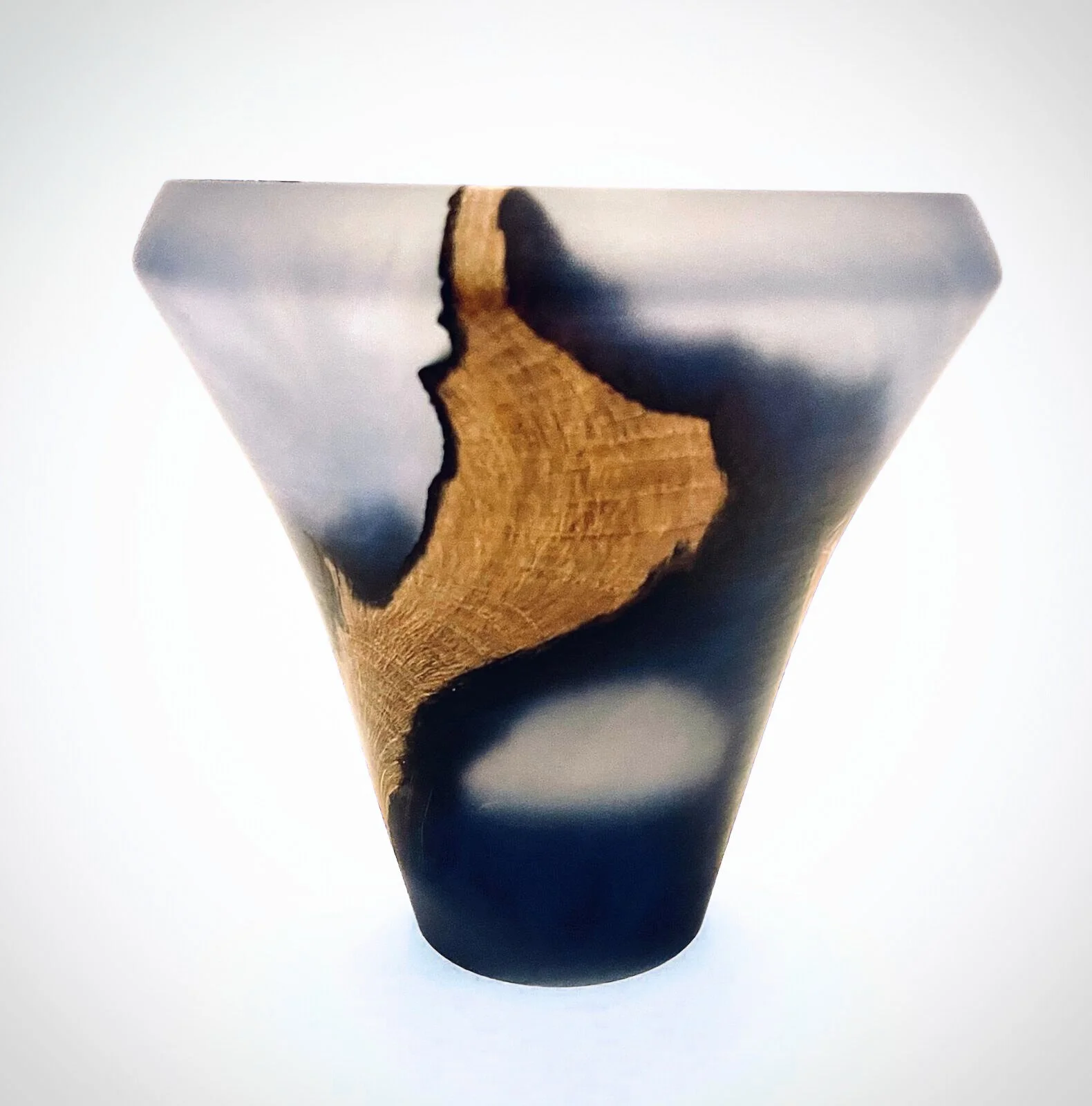 Elegant handturned wood and epoxy vessel  with blues, grays, and natural wood grain.