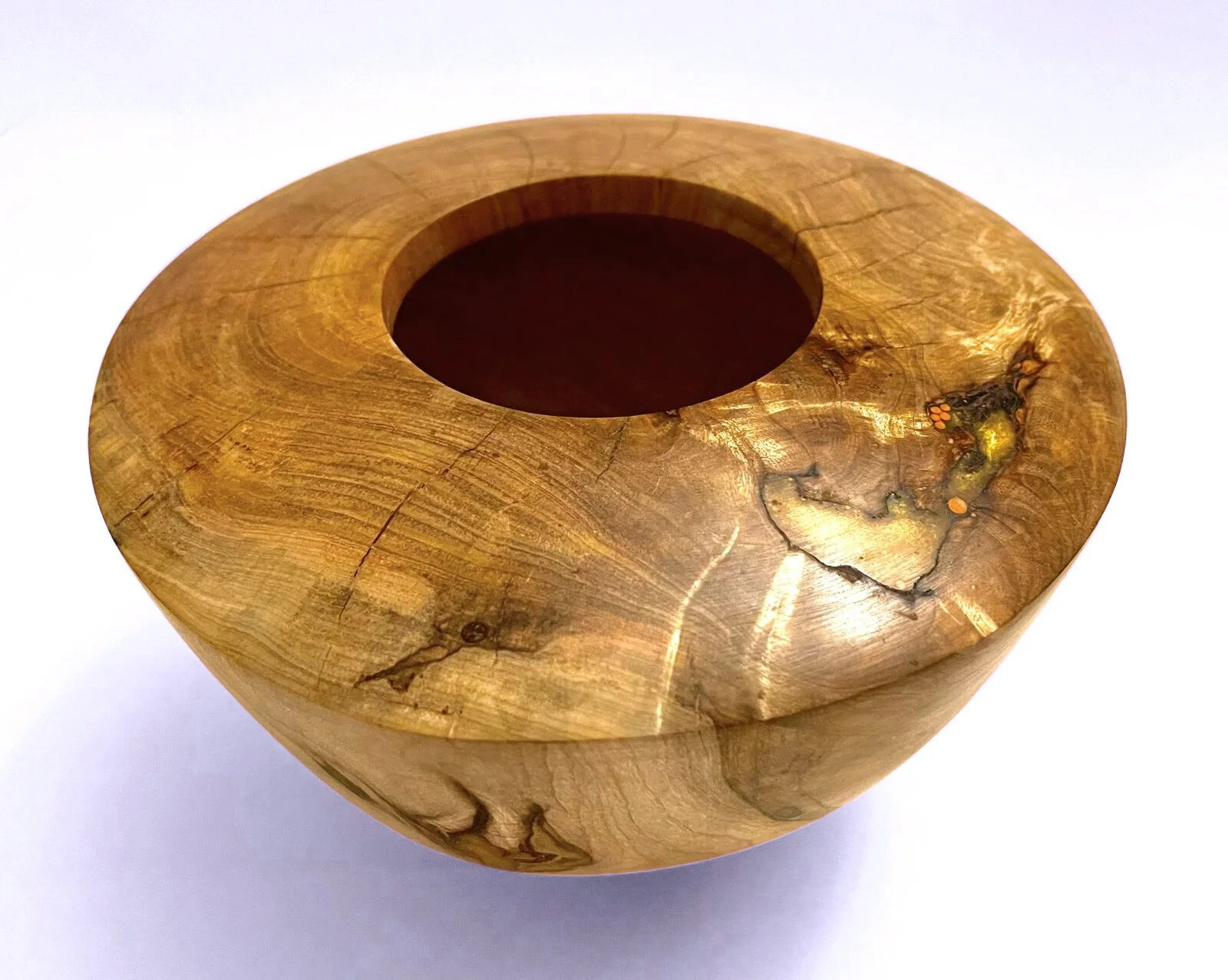 Hand-turned circular wood and epoxy accent bowl with a hollow center and natural wood grain pattern.