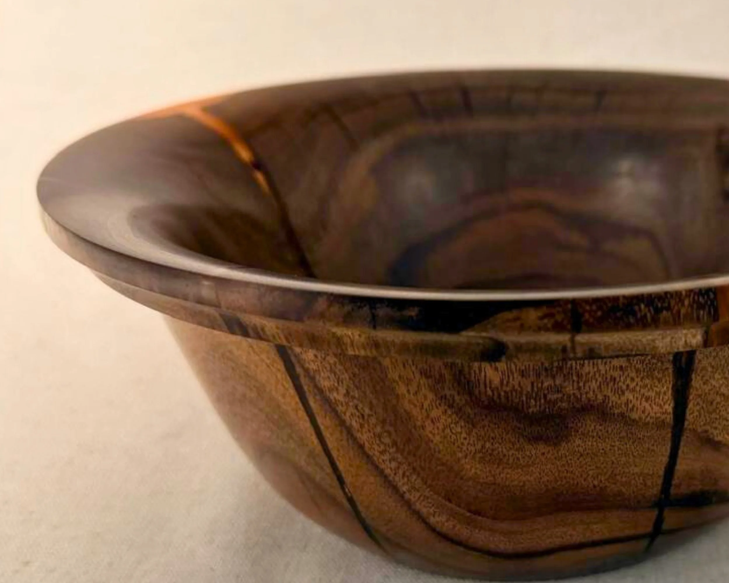 Close-up of rim detail showing bold red epoxy highlighting a section of the rim on claro walnut.