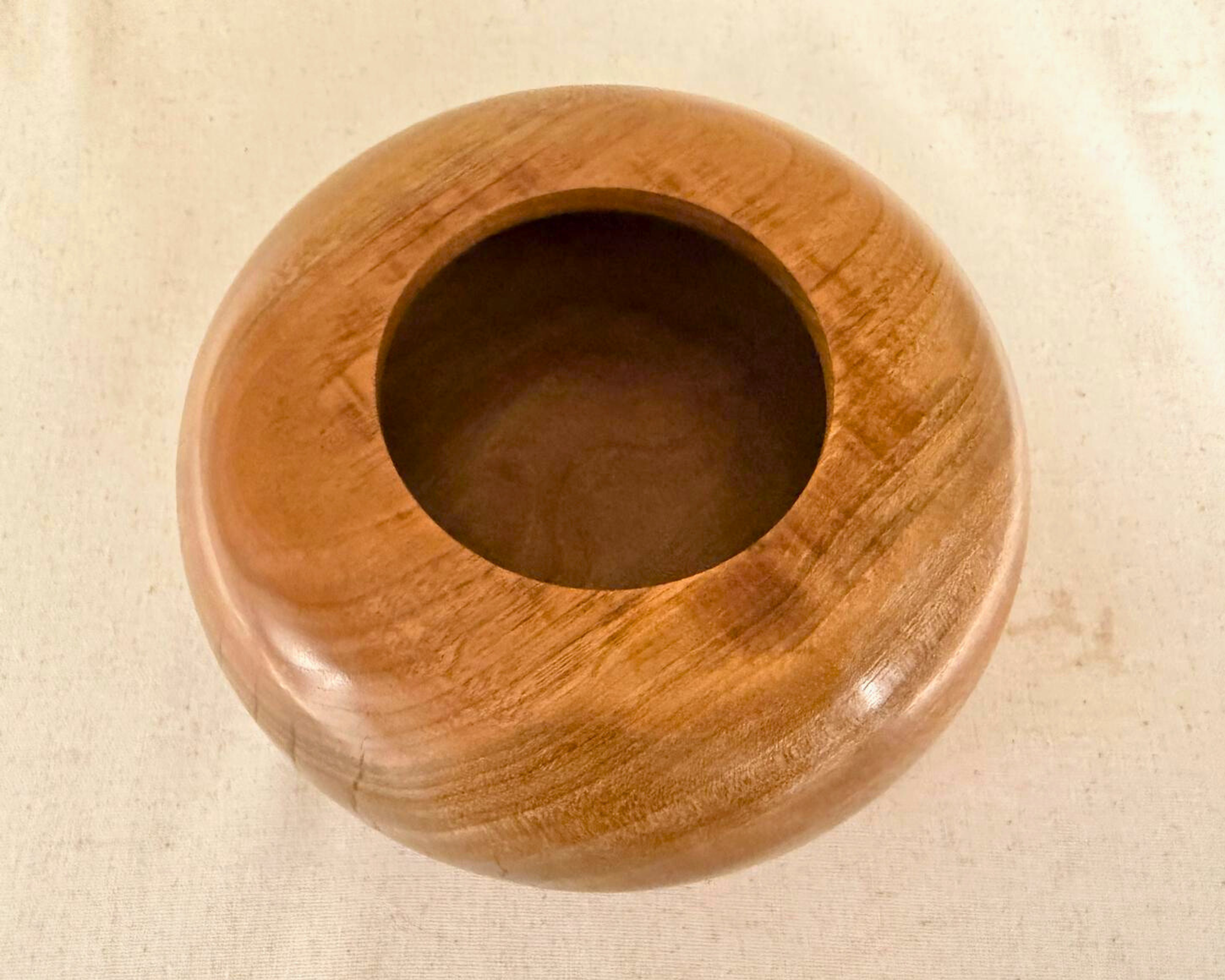 Overhead view of claro walnut closed form with centered opening and visible natural color variation across the surface.