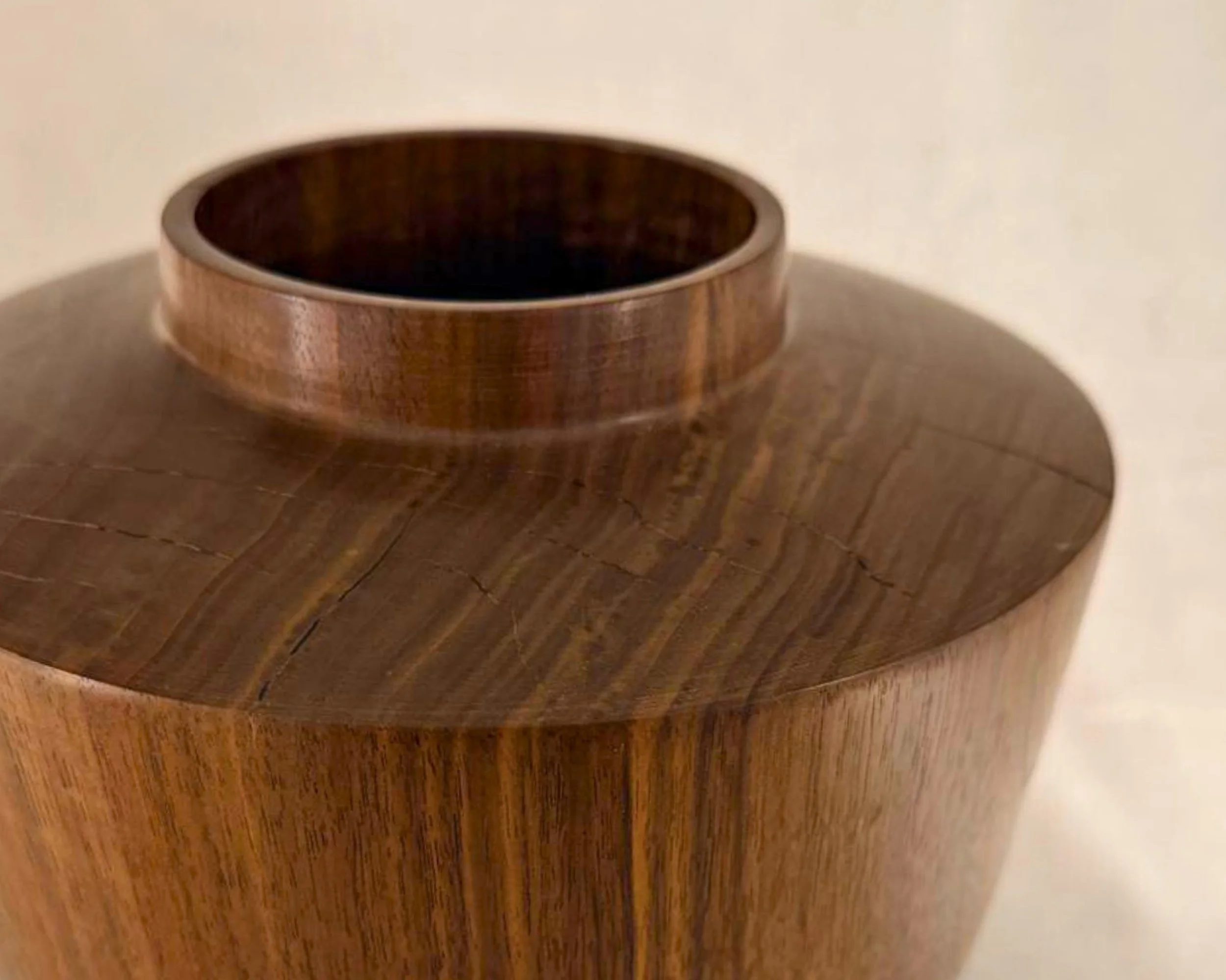 Close-up angled view of the collar opening and shoulder, showing walnut grain and black epoxy-filled checking.