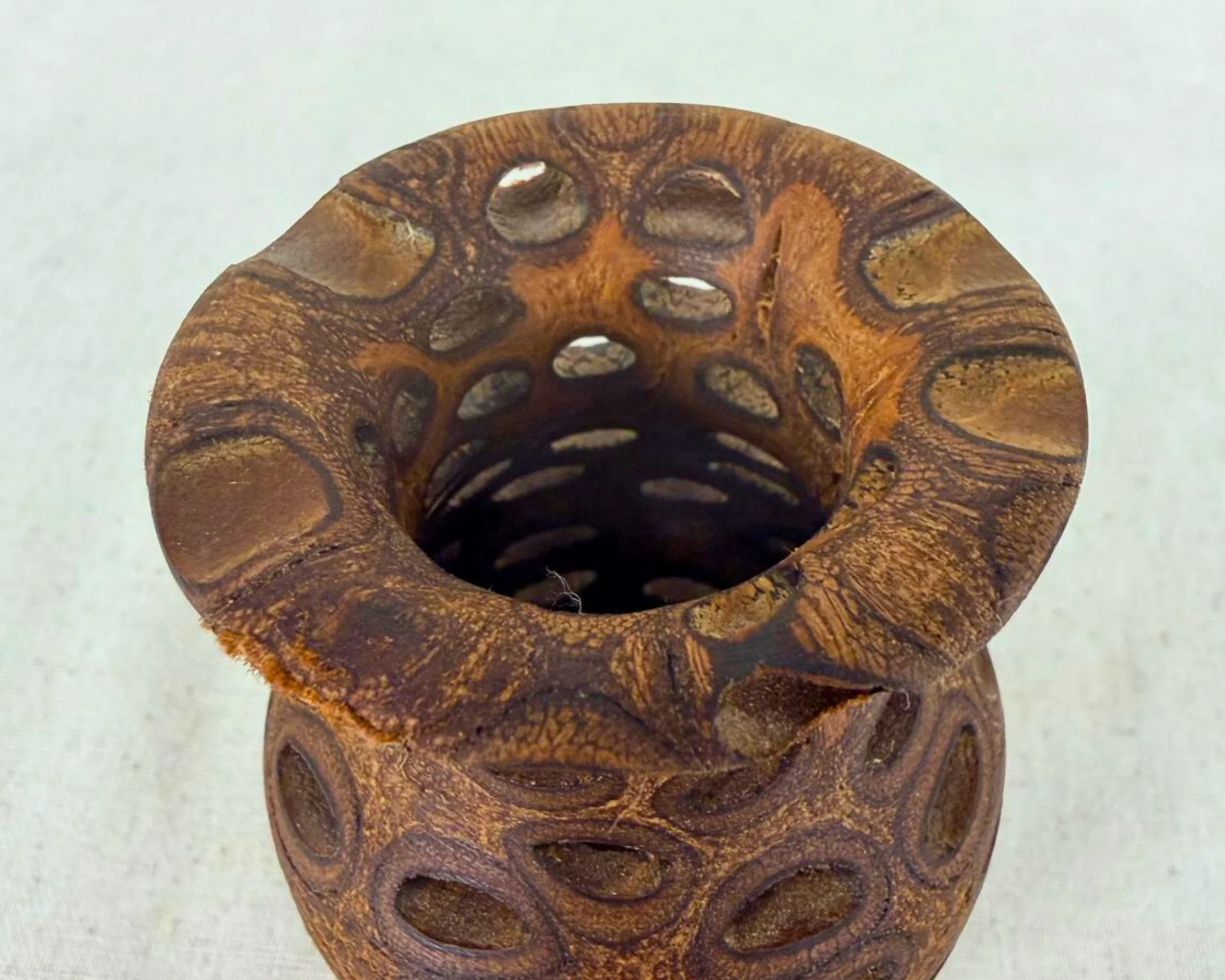Angled top view of banksia nut vase emphasizing rim shape and pierced openings.