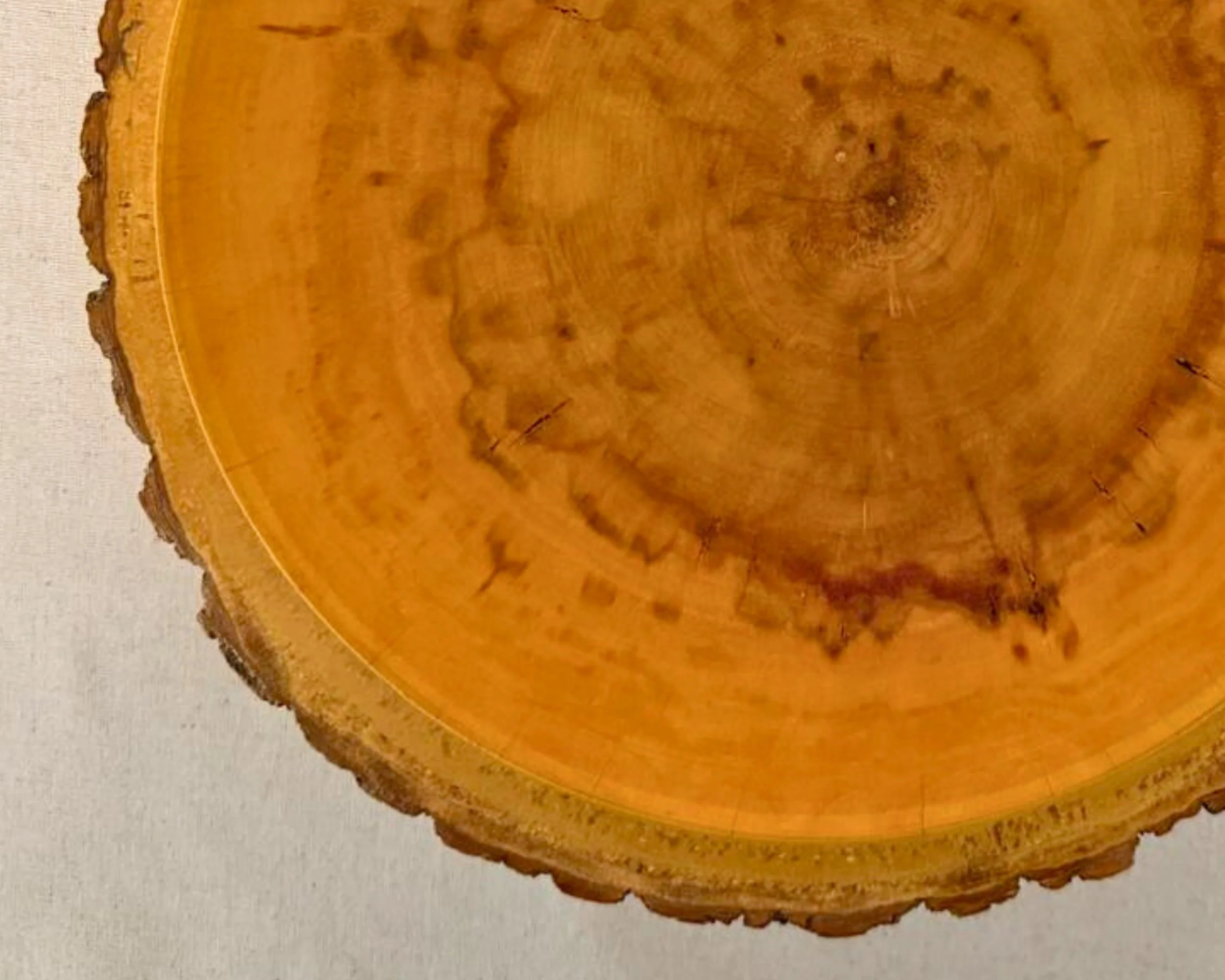 Close-up of walnut bowl interior showing swirling grain and natural color variation.